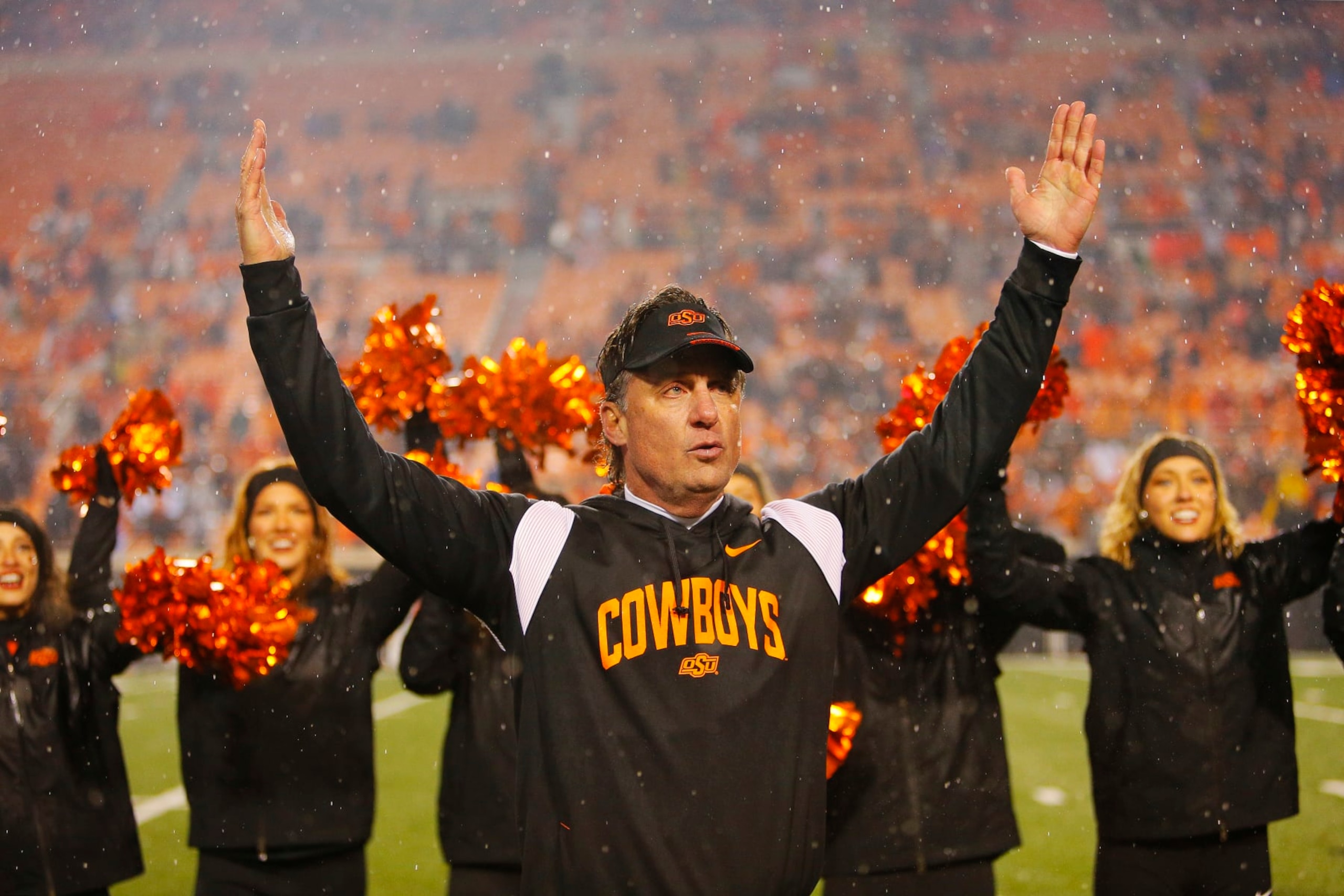 STILLWATER, OK - NOVEMBER 25:  Head coach Mike Gundy of the Oklahoma State Cowboys celebrates a win over the BYU Cougars with the "U" in OSU after their game at Boone Pickens Stadium on November 25, 2023 in Stillwater, Oklahoma.  Oklahoma State won 40-34 in double overtime.  (Photo by Brian Bahr/Getty Images)