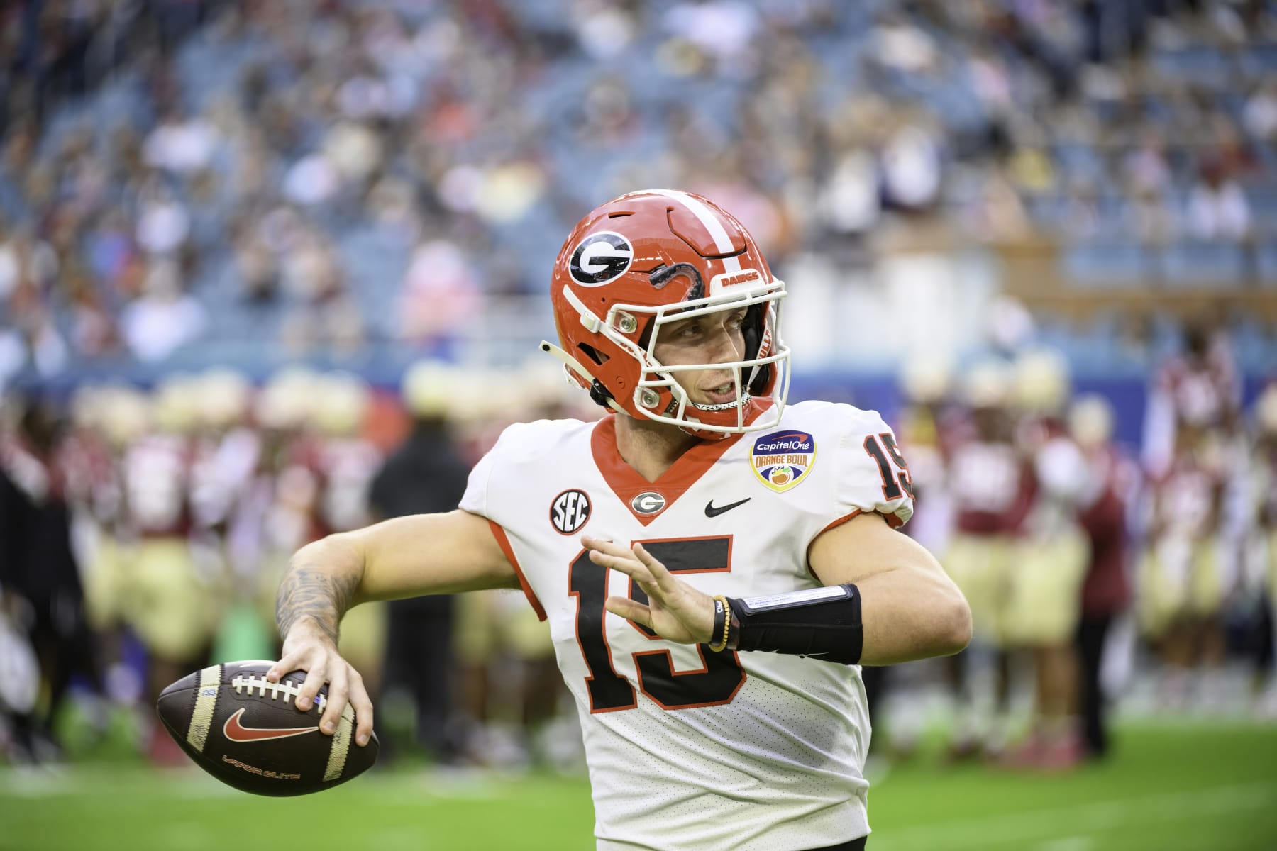 MIAMI GARDENS, FL - DECEMBER 30: Georgia quarterback Carson Beck (15) throws the football on the field as he warms up during the Capital One Orange Bowl college football game between the Georgia Bulldogs and the Florida State Seminoles on December 30, 2023 at the Hard Rock Stadium in Miami Gardens, FL. (Photo by Doug Murray/Icon Sportswire via Getty Images)