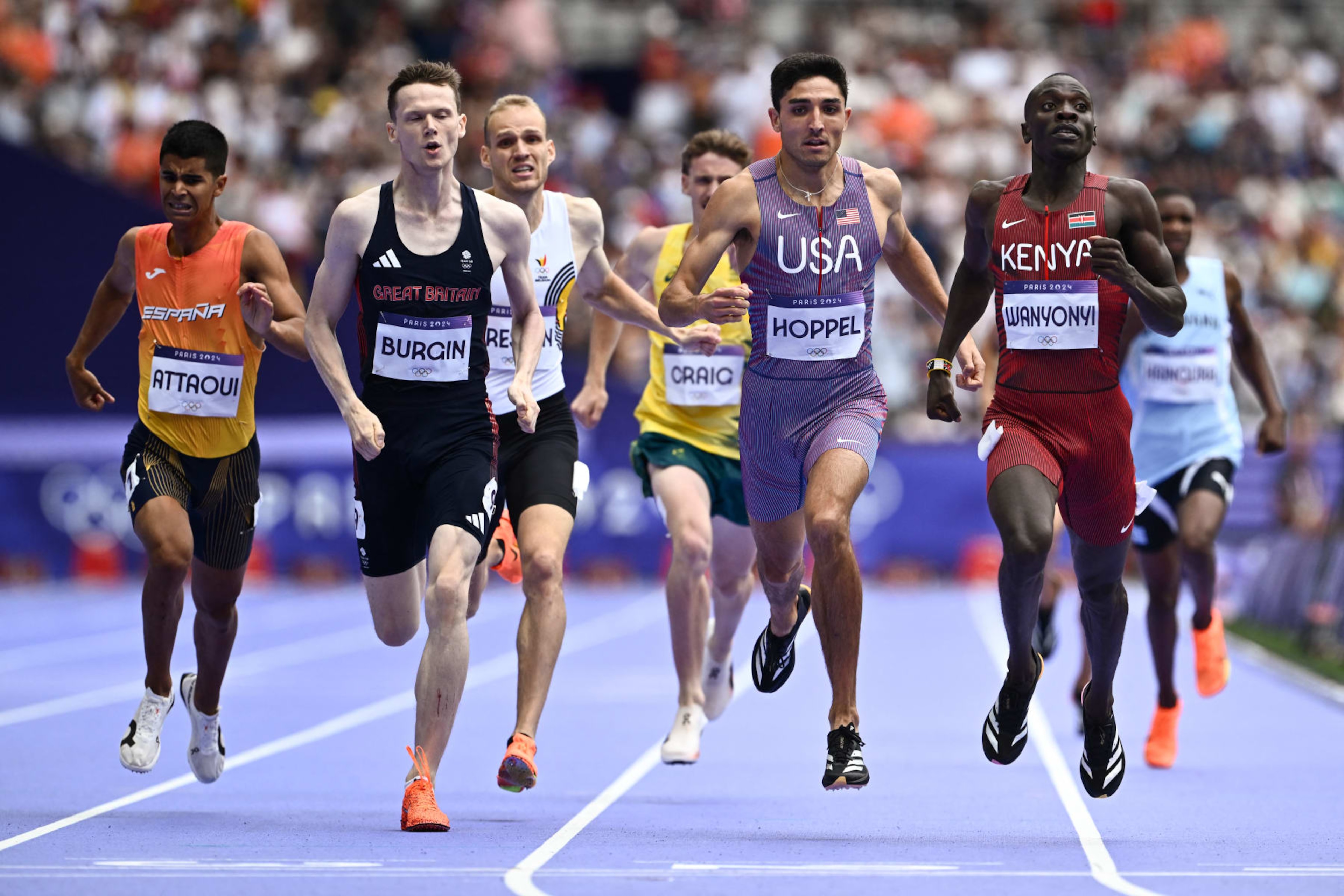 Spain's Mohamed Attaoui, Britain's Max Burgin, Australia's Peyton Craig, US' Bryce Hoppel and Kenya's Emmanuel Wanyonyi compete in the men's 800m semi-final of the athletics event at the Paris 2024 Olympic Games at Stade de France in Saint-Denis, north of Paris, on August 9, 2024. (Photo by Jewel SAMAD / AFP) (Photo by JEWEL SAMAD/AFP via Getty Images)