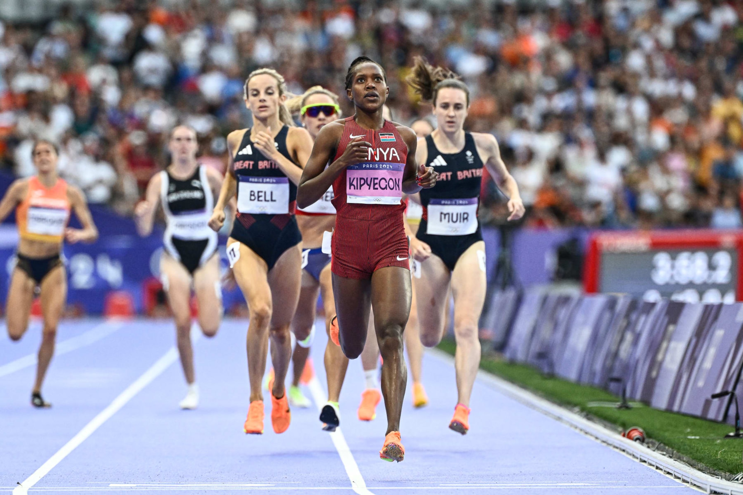 Kenya's Faith Kipyegon crosses the finish line ahead of Britain's Georgia Bell and Britain's Laura Muir in the women's 1500m semi-final of the athletics event at the Paris 2024 Olympic Games at Stade de France in Saint-Denis, north of Paris, on August 8, 2024. (Photo by Jewel SAMAD / AFP) (Photo by JEWEL SAMAD/AFP via Getty Images) Kenya's Faith Kipyegon crosses the finish line ahead of Britain's Georgia Bell and Britain's Laura Muir in the women's 1500m semi-final of the athletics event at the Paris 2024 Olympic Games at Stade de France in Saint-Denis, north of Paris, on August 8, 2024. (Photo by Jewel SAMAD / AFP) (Photo by JEWEL SAMAD/AFP via Getty Images)