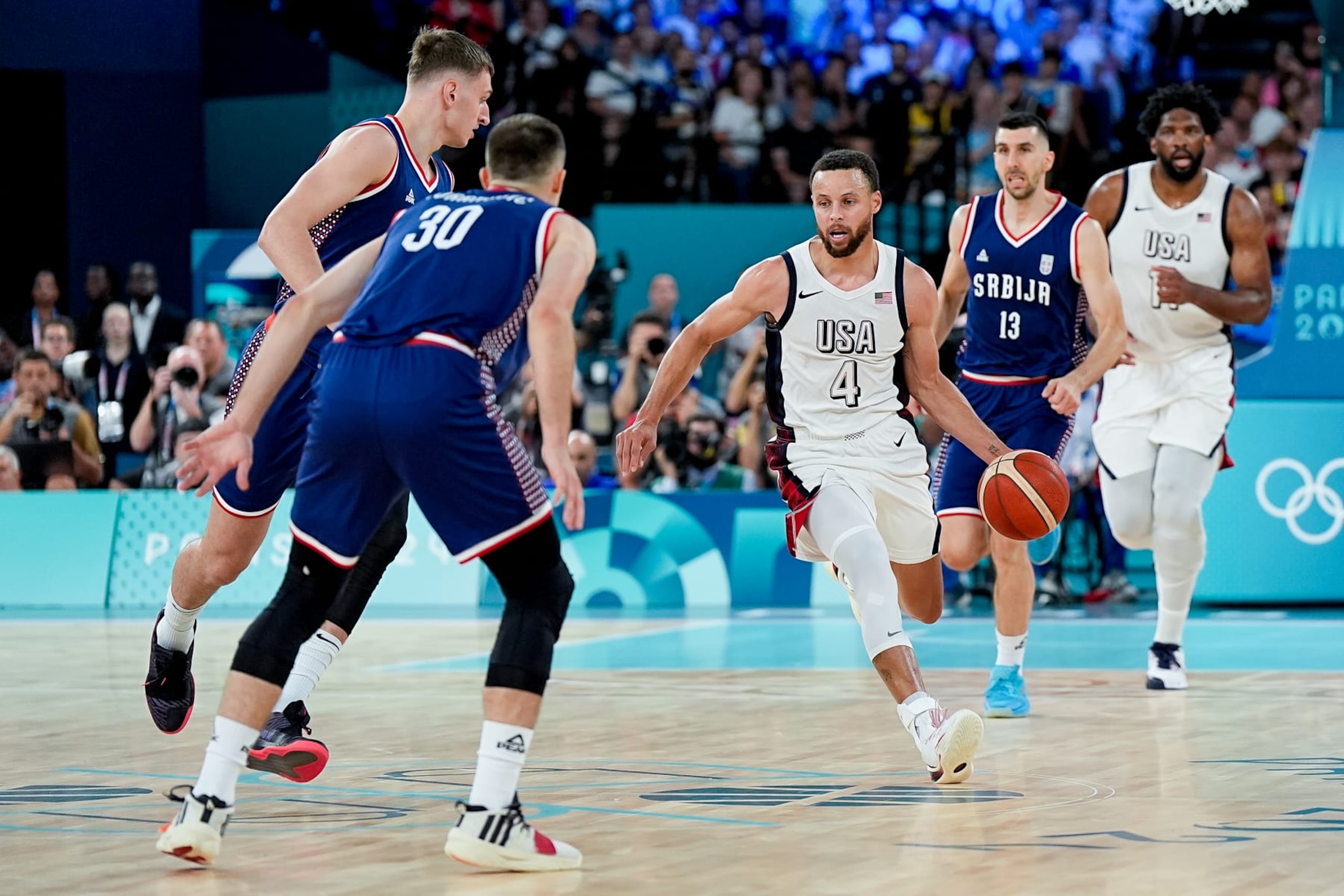 PARIS, FRANCE - AUGUST 8: Stephen Curry of United States handles the ball against Aleksa Avramovic of Serbia (2nd L) during the Men's Semifinal Game between United States and Serbia on day thirteen of the Olympic Games Paris 2024 at Arena Bercy on August 8, 2024 in Paris, France. (Photo by Daniela Porcelli/Eurasia Sport Images/Getty Images)