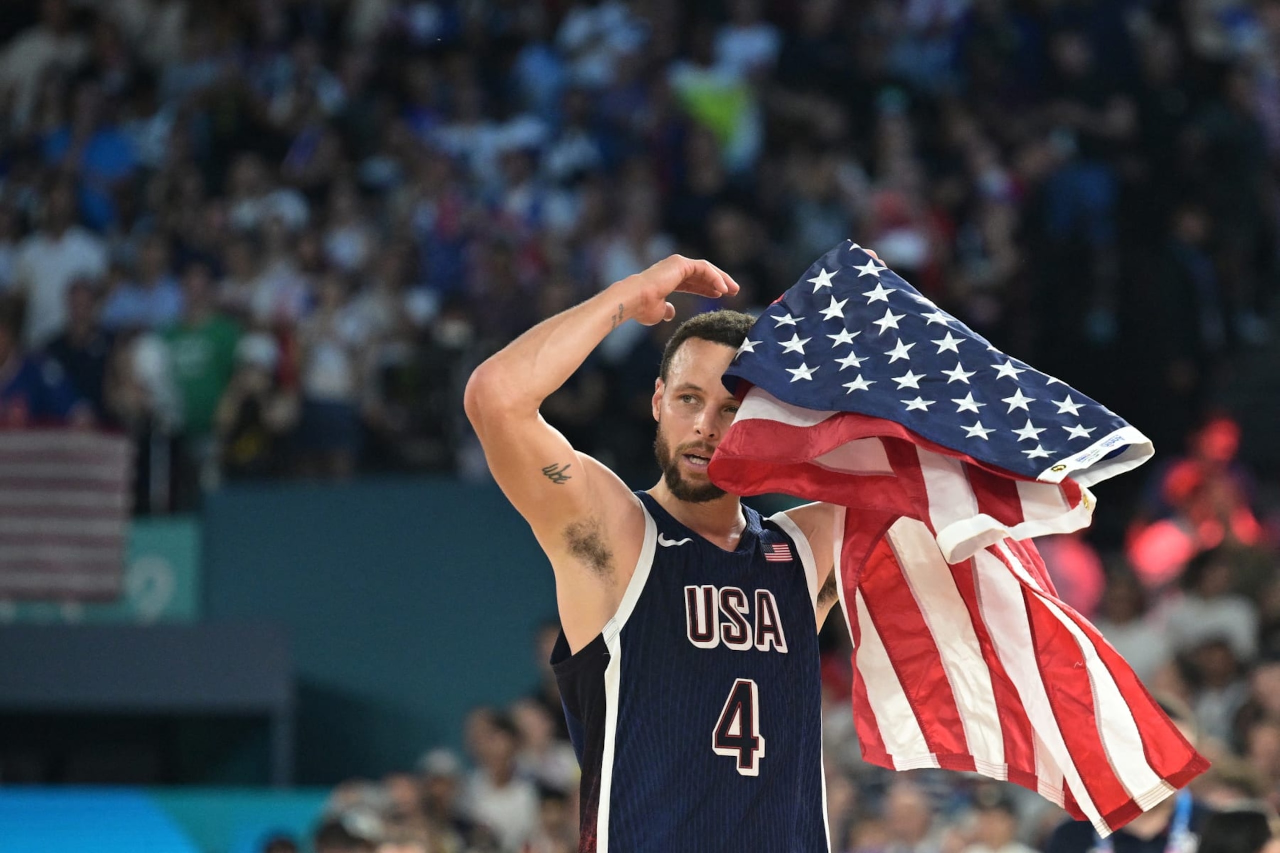 USA's #04 Stephen Curry celebrates after the USA won the men's Gold Medal basketball match between France and USA during the Paris 2024 Olympic Games at the Bercy Arena in Paris on August 10, 2024. (Photo by Damien MEYER / AFP) (Photo by DAMIEN MEYER/AFP via Getty Images) USA's #04 Stephen Curry celebrates after the USA won the men's Gold Medal basketball match between France and USA during the Paris 2024 Olympic Games at the Bercy Arena in Paris on August 10, 2024. (Photo by Damien MEYER / AFP) (Photo by DAMIEN MEYER/AFP via Getty Images)