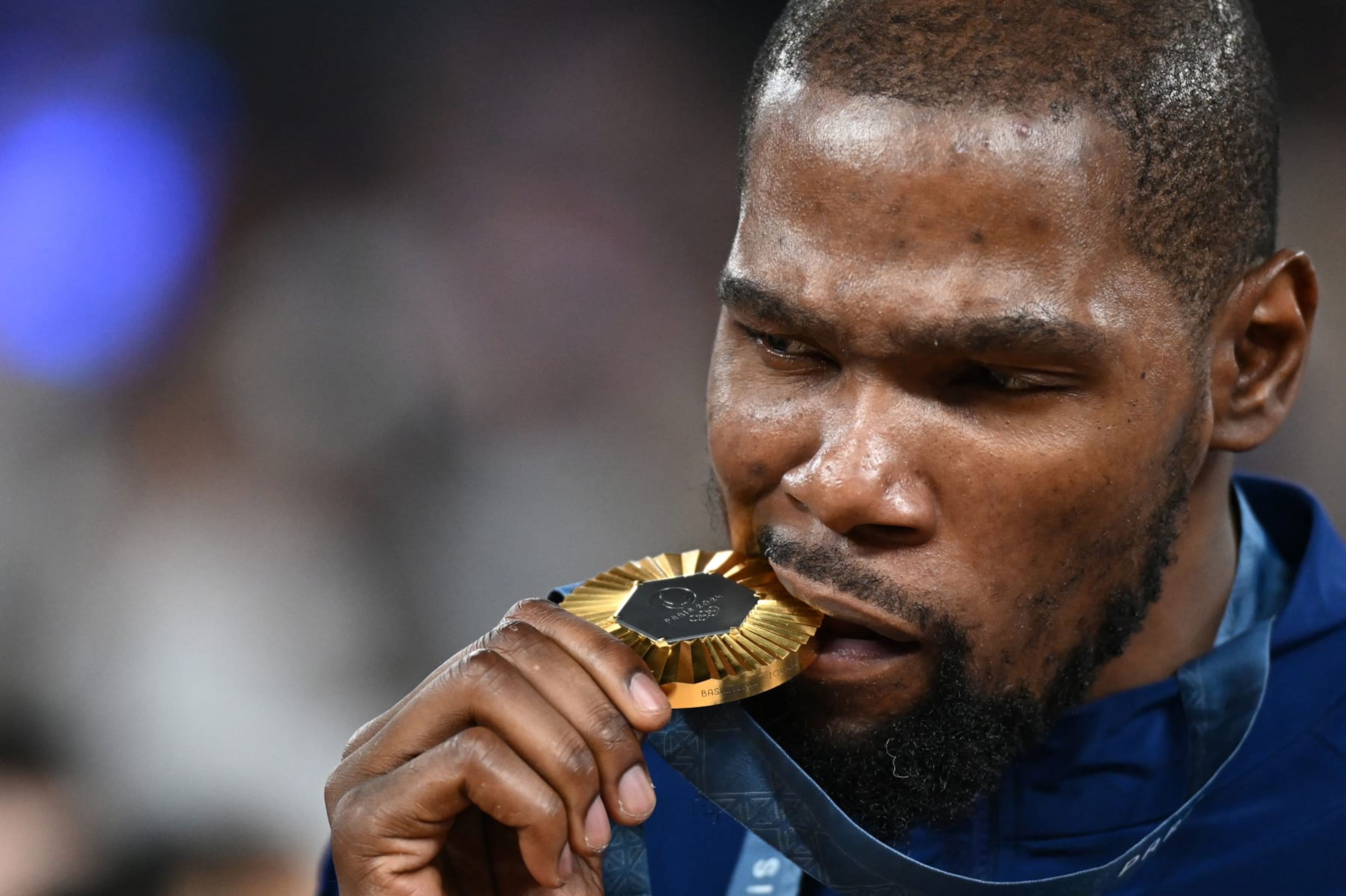 Gold medallist USA's #07 Kevin Durant poses on the podium after the men's Gold Medal basketball match between France and USA during the Paris 2024 Olympic Games at the Bercy Arena in Paris on August 10, 2024. (Photo by Aris MESSINIS / AFP) (Photo by ARIS MESSINIS/AFP via Getty Images) Gold medallist USA's #07 Kevin Durant poses on the podium after the men's Gold Medal basketball match between France and USA during the Paris 2024 Olympic Games at the Bercy Arena in Paris on August 10, 2024. (Photo by Aris MESSINIS / AFP) (Photo by ARIS MESSINIS/AFP via Getty Images)