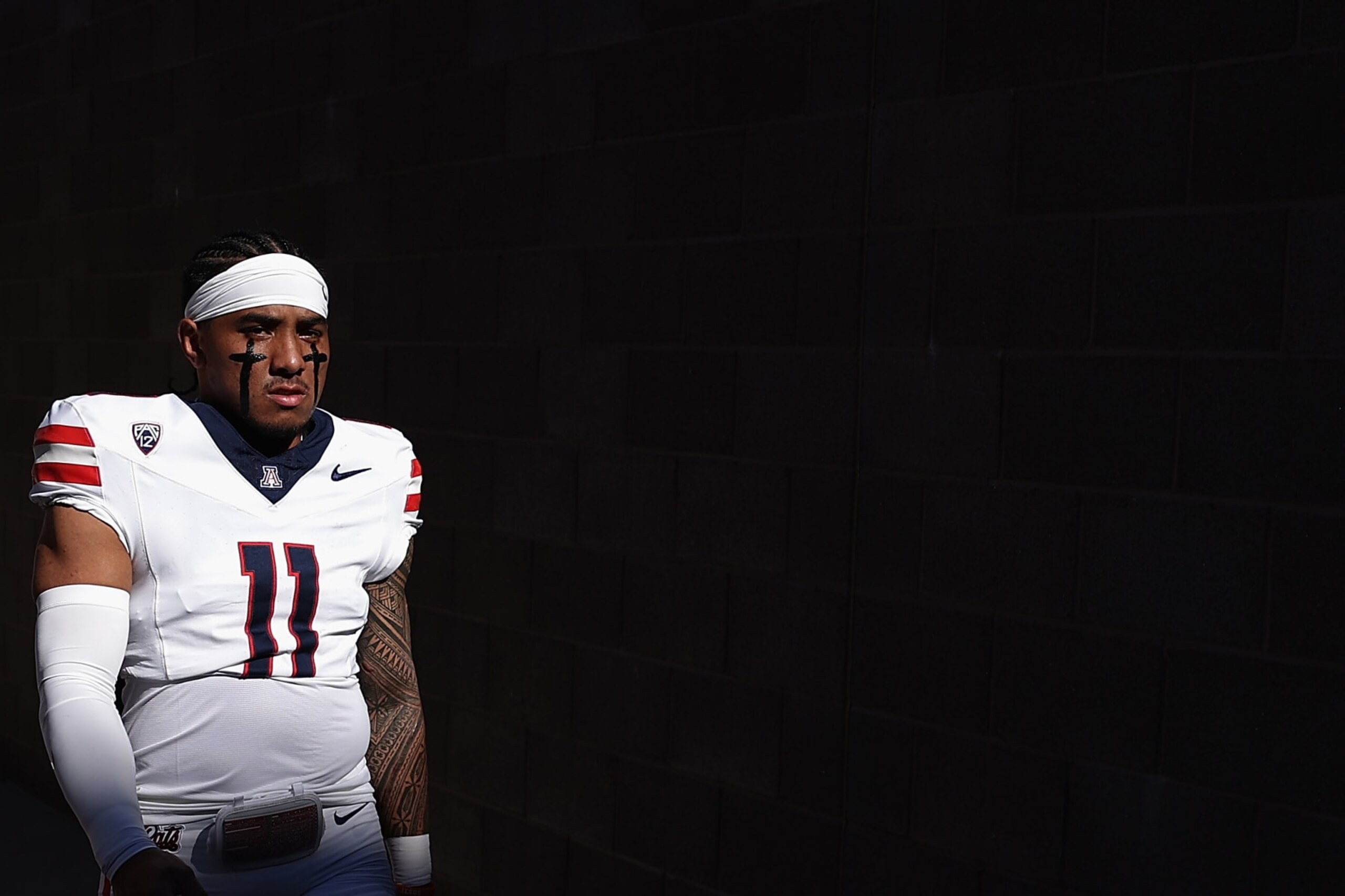 TEMPE, ARIZONA - NOVEMBER 25: Quarterback Noah Fifita #11 of the Arizona Wildcats walks out to the field before the NCAAF game against the Arizona State Sun Devils at Mountain America Stadium on November 25, 2023 in Tempe, Arizona. (Photo by Christian Petersen/Getty Images)