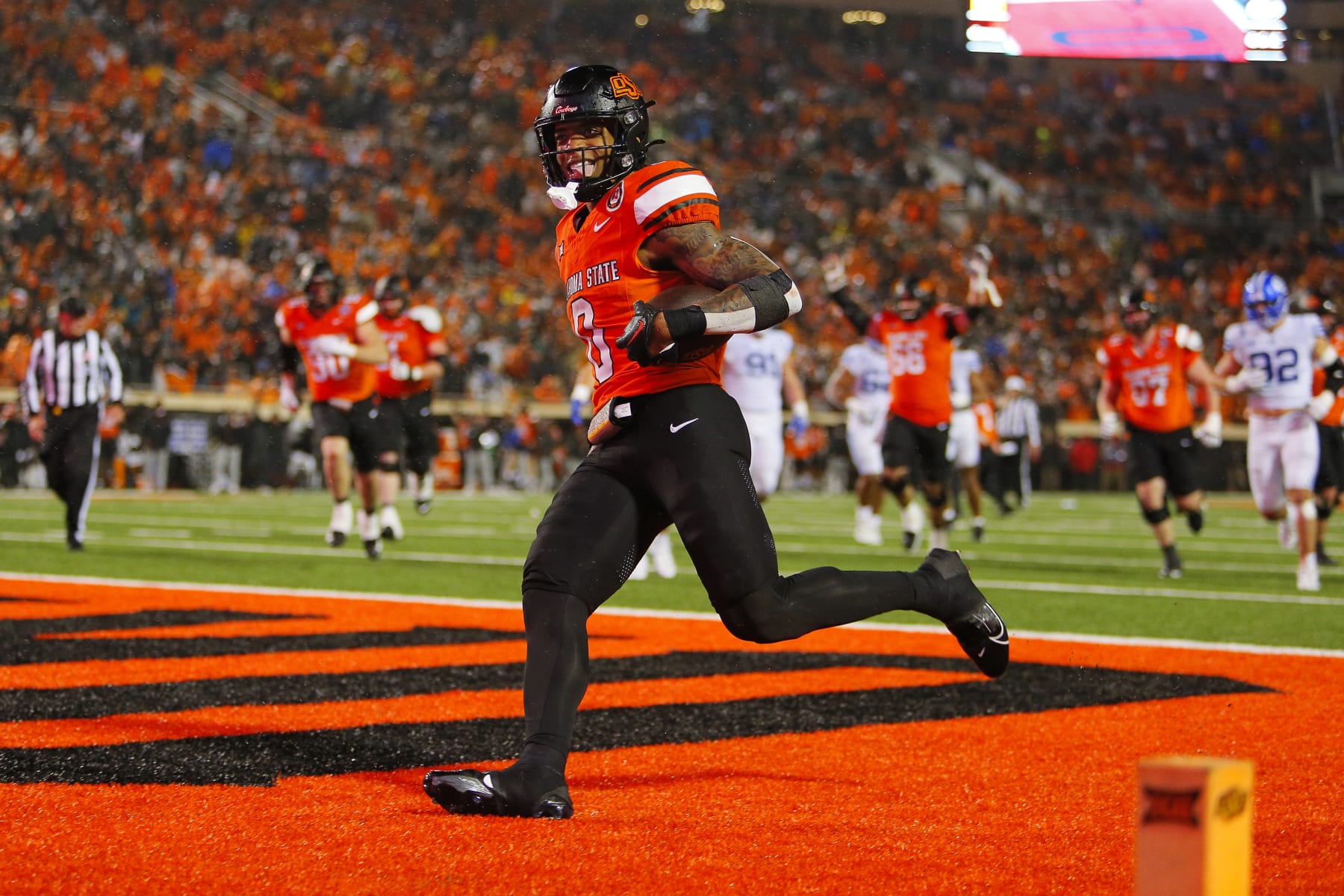 STILLWATER, OK - NOVEMBER 25:  Running back Ollie Gordon II #0 of the Oklahoma State Cowboys sticks out his tongue after scoring a go-ahead touchdown against the BYU Cougars late in the fourth quarter at Boone Pickens Stadium on November 25, 2023 in Stillwater, Oklahoma.  Oklahoma State won 40-34 in double overtime.  (Photo by Brian Bahr/Getty Images)