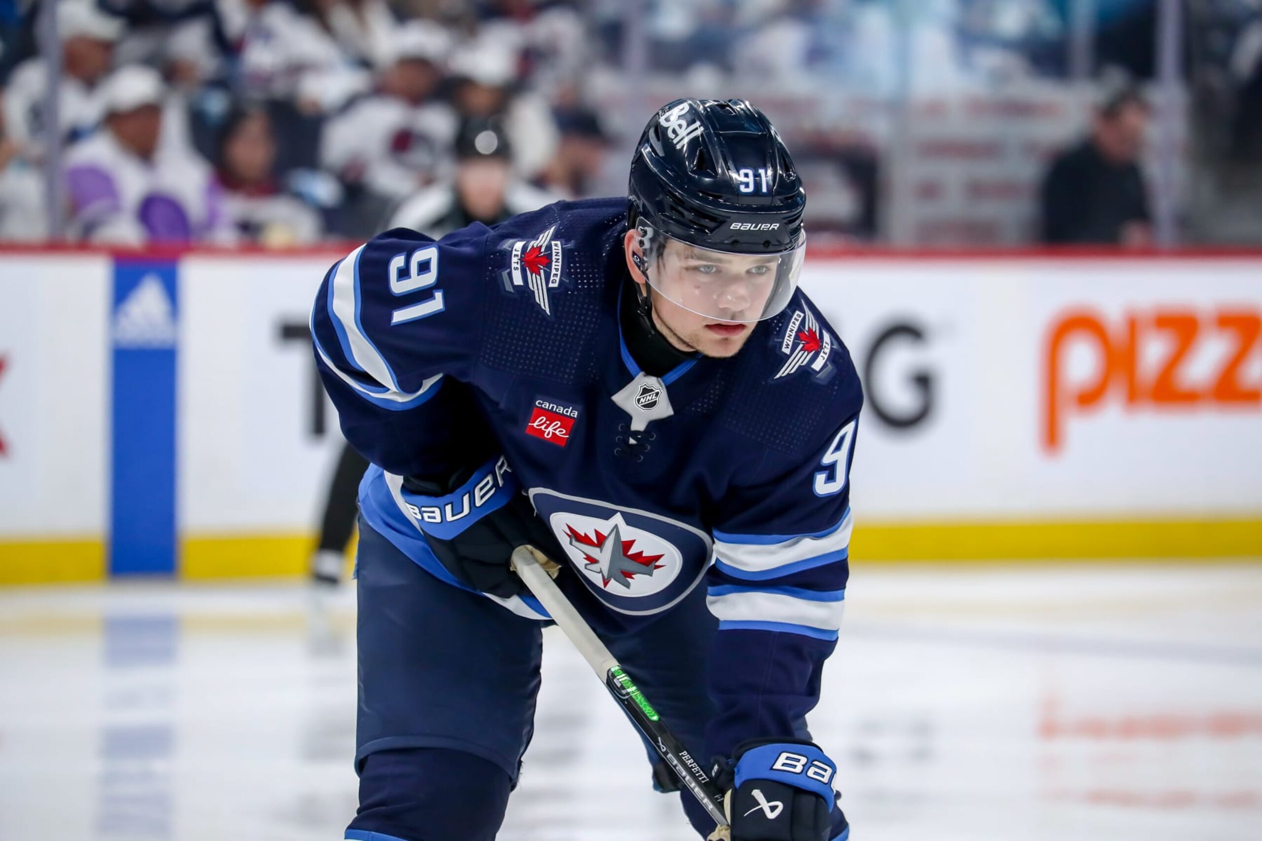 WINNIPEG, CANADA - APRIL 30: Cole Perfetti #91 of the Winnipeg Jets looks on during a second period face-off against the Colorado Avalanche in Game Five of the First Round of the 2024 Stanley Cup Playoffs at the Canada Life Centre on April 30, 2024 in Winnipeg, Manitoba, Canada. The Avs defeated the Jets 6-3 and win the series 4-1. (Photo by Darcy Finley/NHLI via Getty Images)