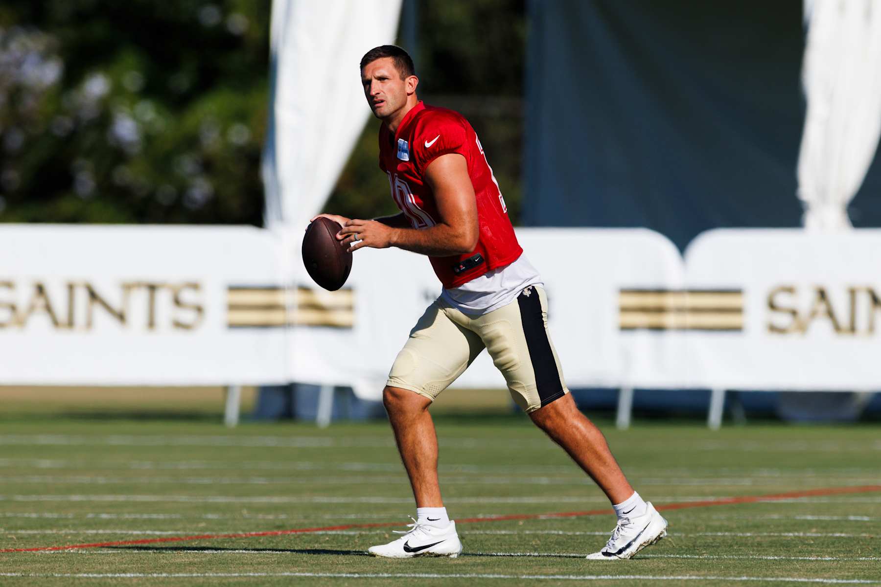 IRVINE, CALIFORNIA - JULY 29: Nathan Peterman #10 of the New Orleans Saints drops back to pass during training camp at University of California Irvine on July 29, 2024 in Irvine, California.  (Photo by Ric Tapia/Getty Images)