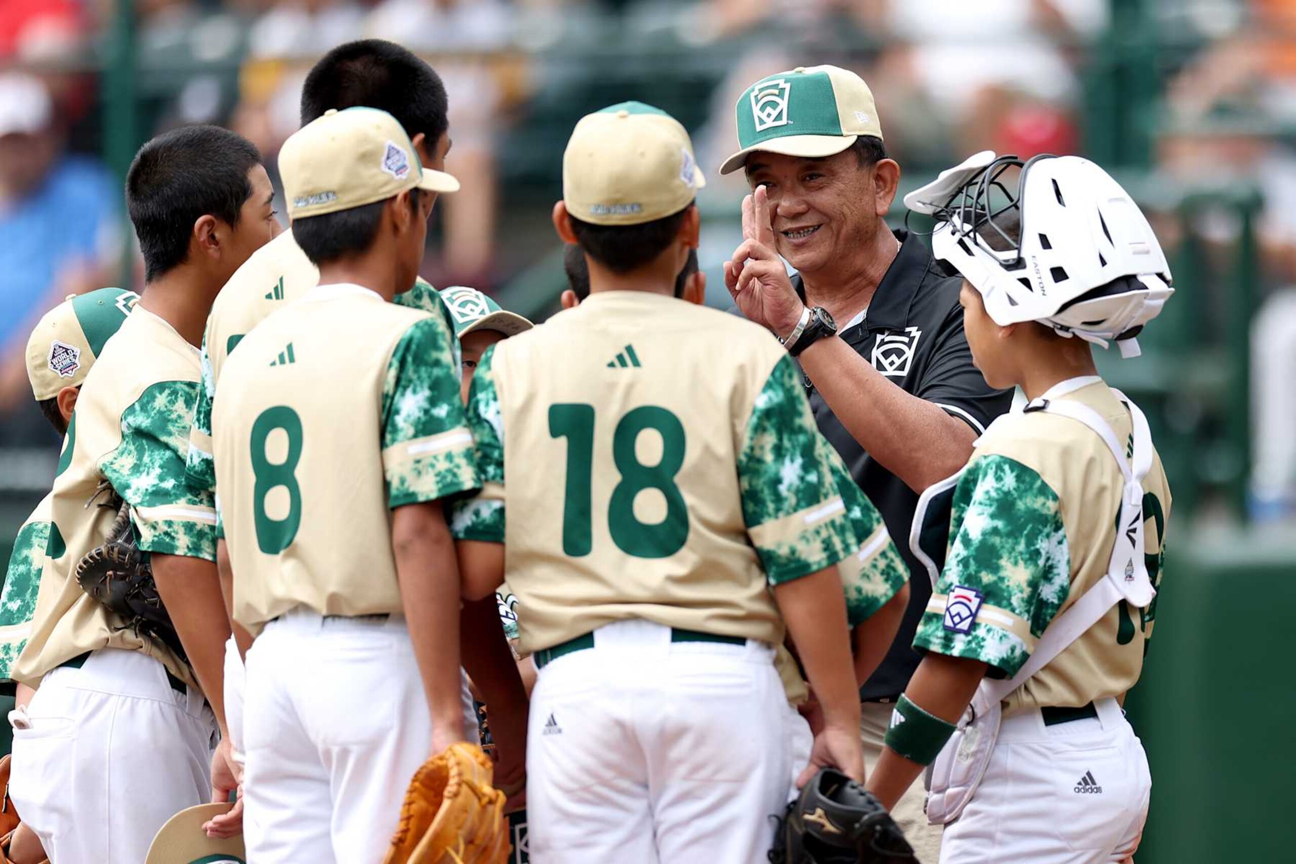 SOUTH WILLIAMSPORT, PENNSYLVANIA - AUGUST 27: Lee Cheng-Ta, manager of the Asia-Pacific Region team from Taipei City, Chinese Taipei, speaks with players during the fourth inning against the Southwest Region team from Needville, Texas during the Little League World Series Consolation Game at Little League International Complex on August 27, 2023 in South Williamsport, Pennsylvania. (Photo by Tim Nwachukwu/Getty Images)