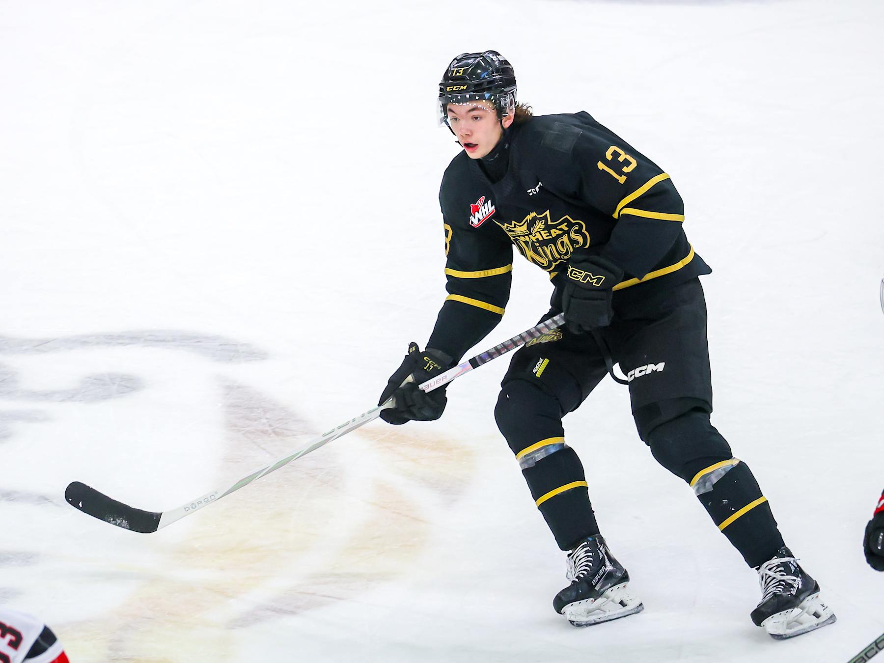 BRANDON, CANADA - APRIL 03: Roger McQueen #13 of the Brandon Wheat Kings skates during first period action against the Moose Jaw Warriors in Game Three of the First Round of the 2024 WHL Playoffs at Westoba Place on April 03, 2024 in Brandon, Manitoba, Canada. (Photo by Jonathan Kozub/Getty Images)