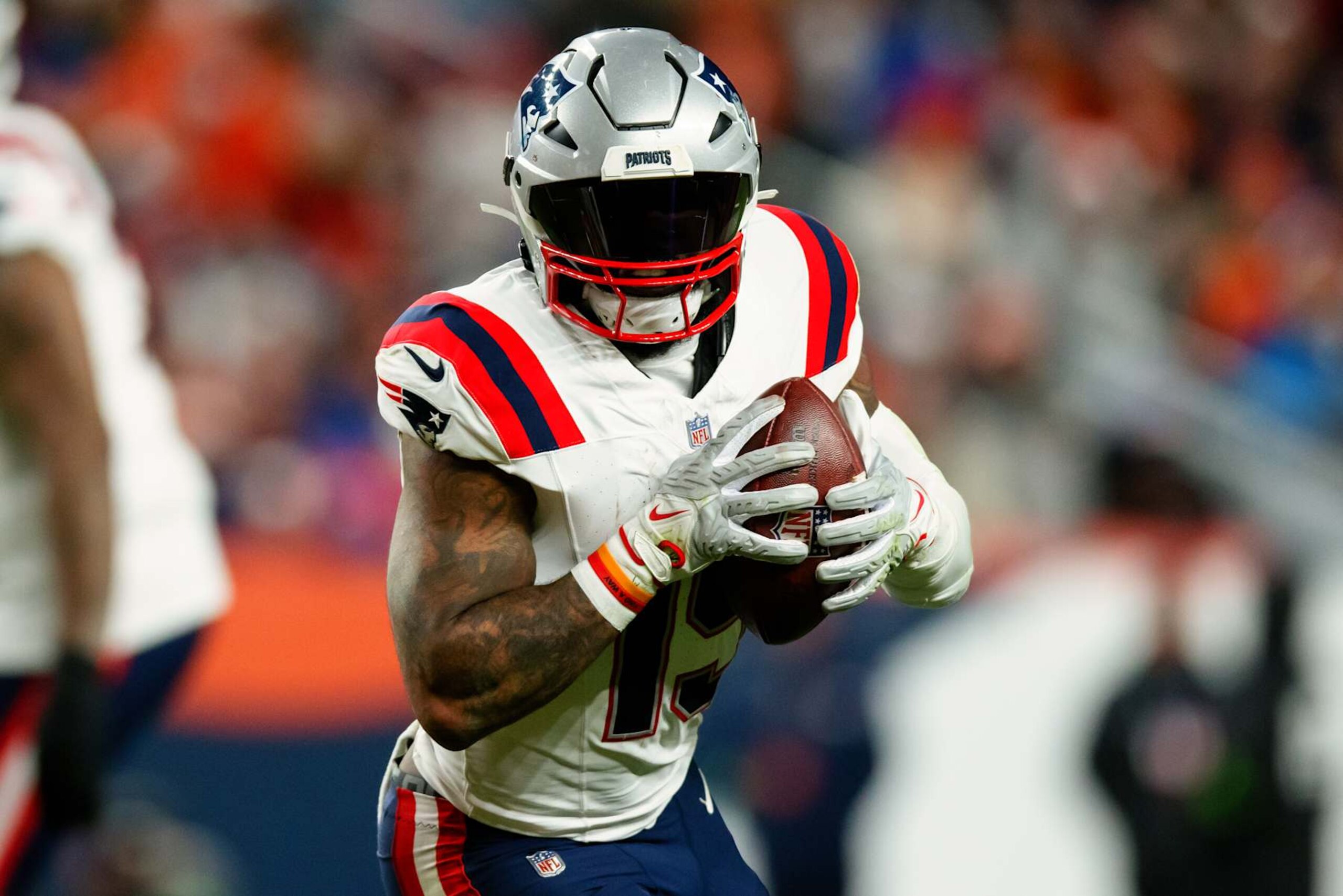 DENVER, CO - JANUARY 24:  Running back Ezekiel Elliott #15 of the New England Patriots runs with the football during the third quarter against the Denver Broncos at Empower Field at Mile High on December 24, 2023 in Denver, Colorado. (Photo by Justin Edmonds/Getty Images)