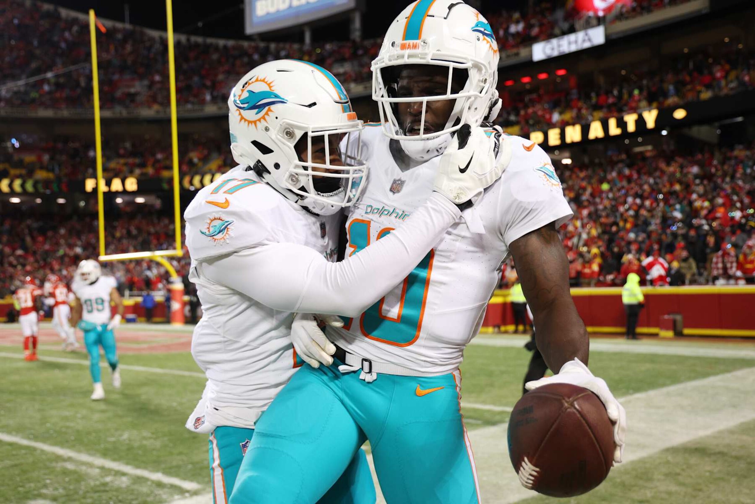 KANSAS CITY, MISSOURI - JANUARY 13: Tyreek Hill #10 of the Miami Dolphins celebrates with Jaylen Waddle #17 after scoring a touchdown during the second quarter against the Kansas City Chiefs in the AFC Wild Card Playoffs at GEHA Field at Arrowhead Stadium on January 13, 2024 in Kansas City, Missouri. (Photo by Jamie Squire/Getty Images)