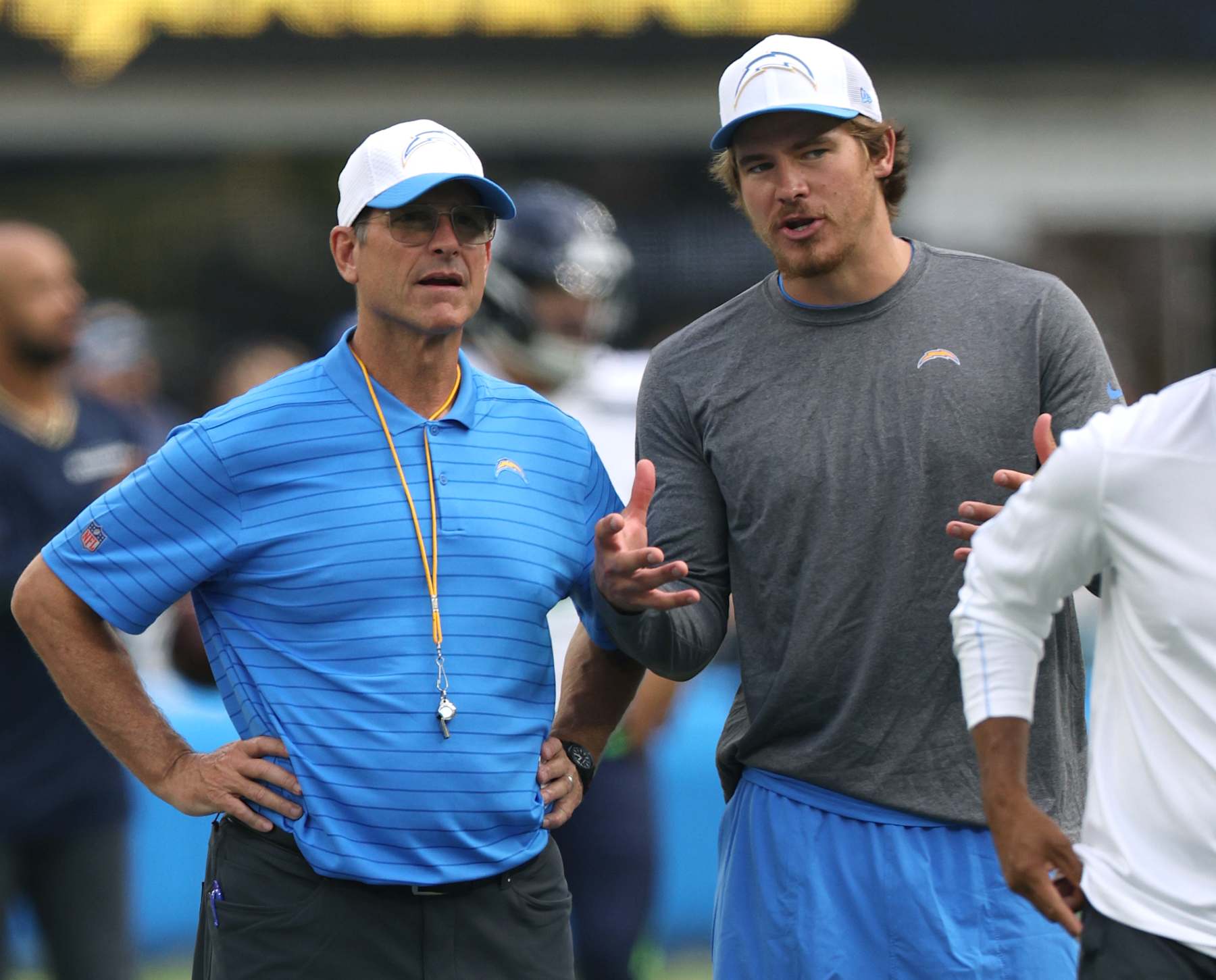 INGLEWOOD, CALIFORNIA - AUGUST 10: Head coach Jim Harbaugh and Justin Herbert #10 of the Los Angeles Chargers talk before a preseason game against the Seattle Seahawks at SoFi Stadium on August 10, 2024 in Inglewood, California. (Photo by Harry How/Getty Images)