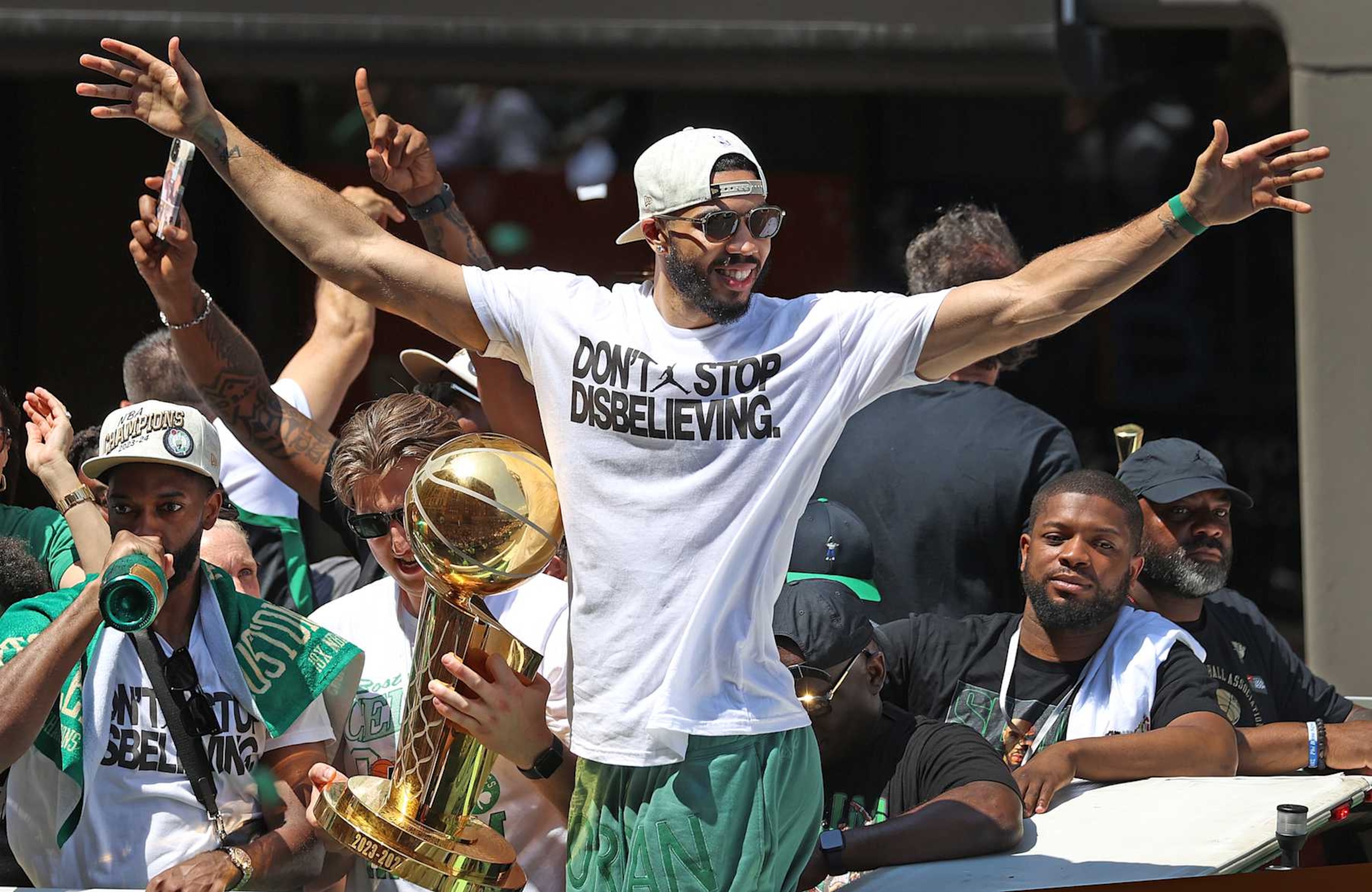Boston, MA - June 21: Boston Celtics SF Jayson Tatum spreads out his arms during a duck boat parade to celebrate the 18th Boston Celtics NBA championship. (Photo by David L. Ryan/The Boston Globe via Getty Images)