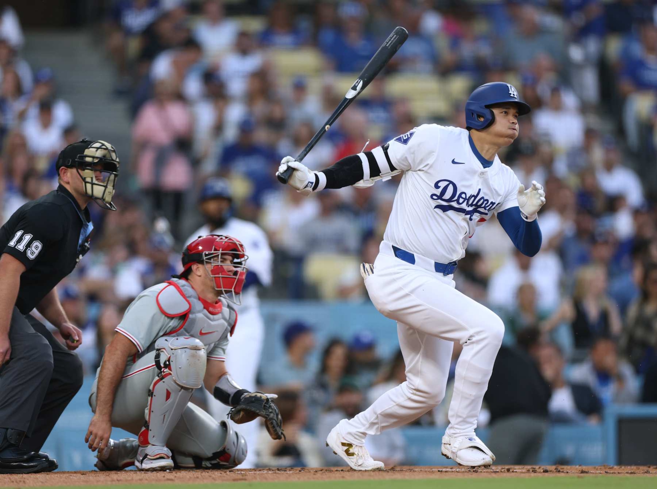 LOS ANGELES, CALIFORNIA - AUGUST 07: Shohei Ohtani #17 of the Los Angeles Dodgers reacts to his ground out in front of J.T. Realmuto #10 of the Philadelphia Phillies and umpire Brock Ballou during the first inning against the Philadelphia Phillies at Dodger Stadium on August 07, 2024 in Los Angeles, California. (Photo by Harry How/Getty Images)