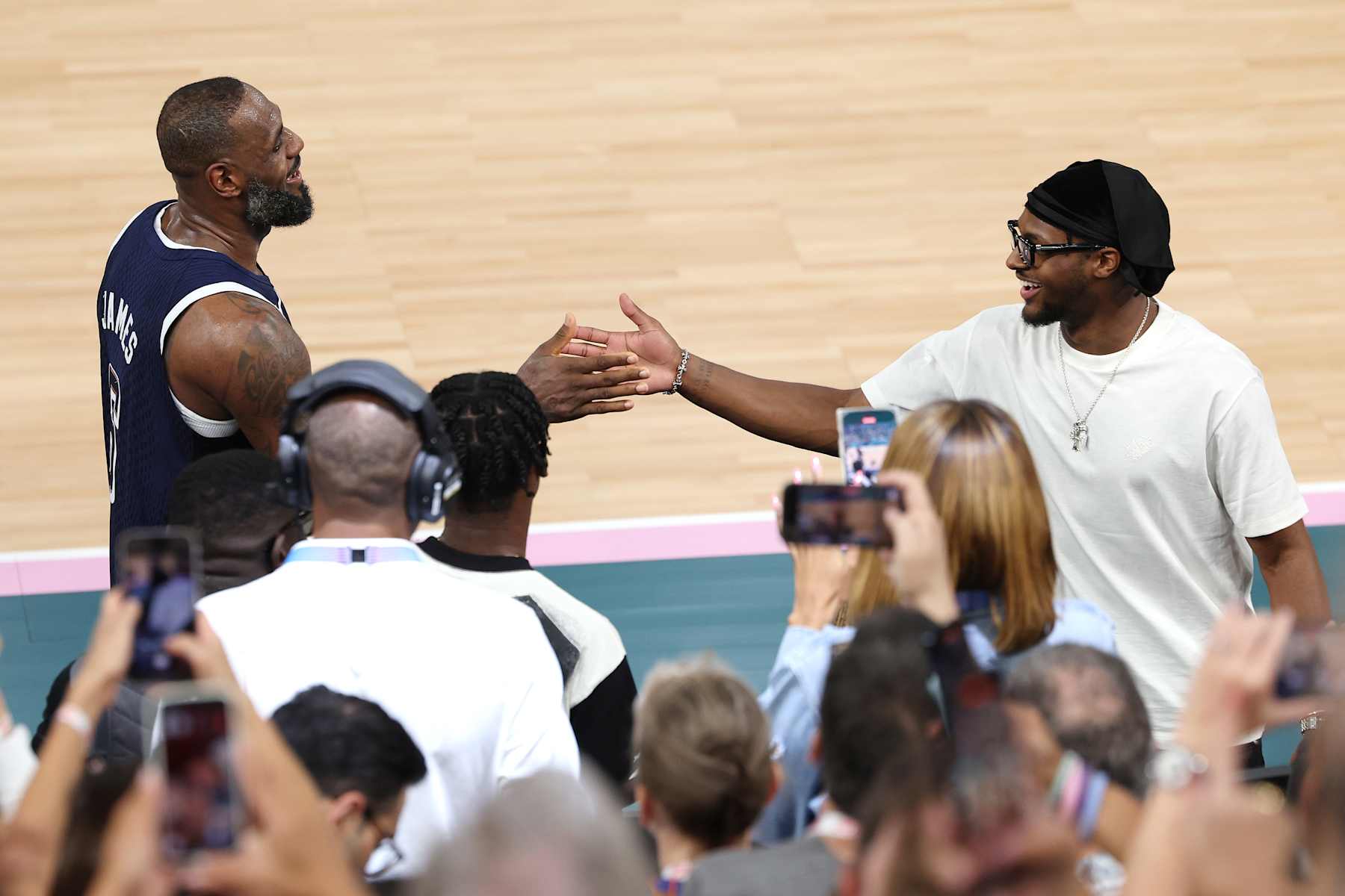 PARIS, FRANCE - AUGUST 10: LeBron James #6 of Team United States high fives his son and NBA player Bronny James after Team United States' victory against Team France during the Men's Gold Medal game between Team France and Team United States on day fifteen of the Olympic Games Paris 2024 at Bercy Arena on August 10, 2024 in Paris, France. (Photo by Jamie Squire/Getty Images)