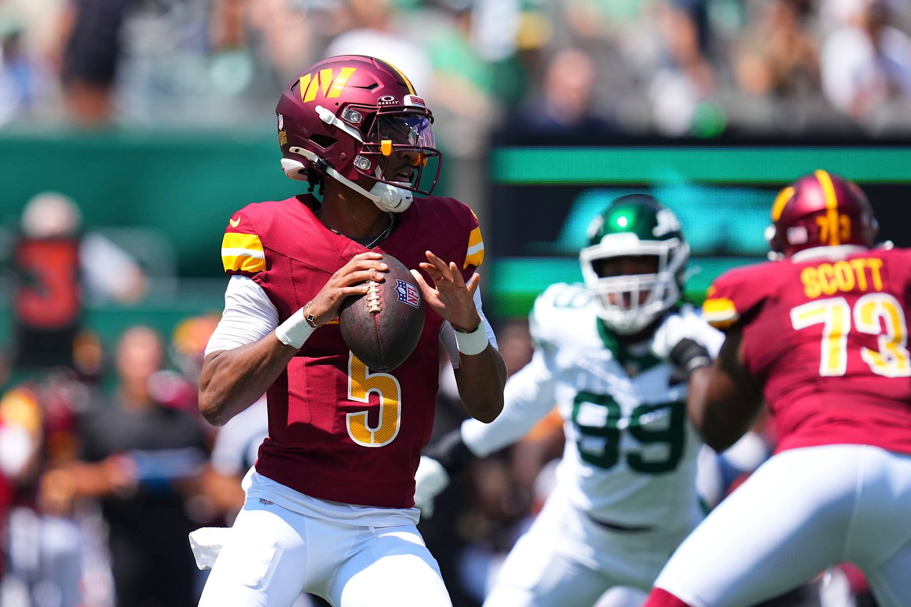 EAST RUTHERFORD, NEW JERSEY - AUGUST 10: Jayden Daniels #5 of the Washington Commanders passes the ball against the New York Jets during the preseason game at MetLife Stadium on August 10, 2024 in East Rutherford, New Jersey. The Jets defeated the Commanders 20-17. (Photo by Mitchell Leff/Getty Images)