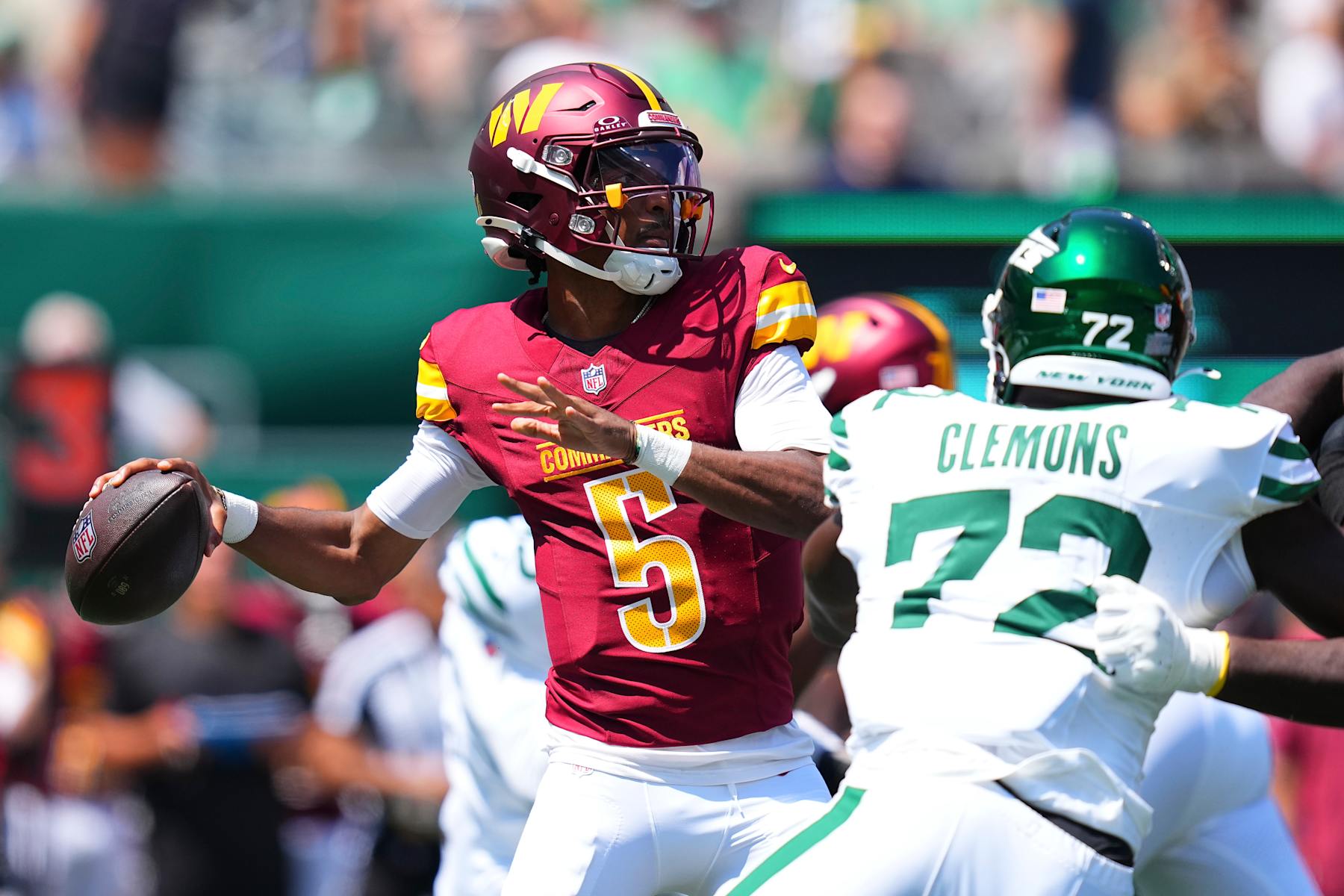 EAST RUTHERFORD, NEW JERSEY - AUGUST 10: Jayden Daniels #5 of the Washington Commanders passes the ball against the New York Jets during the preseason game at MetLife Stadium on August 10, 2024 in East Rutherford, New Jersey. The Jets defeated the Commanders 20-17. (Photo by Mitchell Leff/Getty Images)
