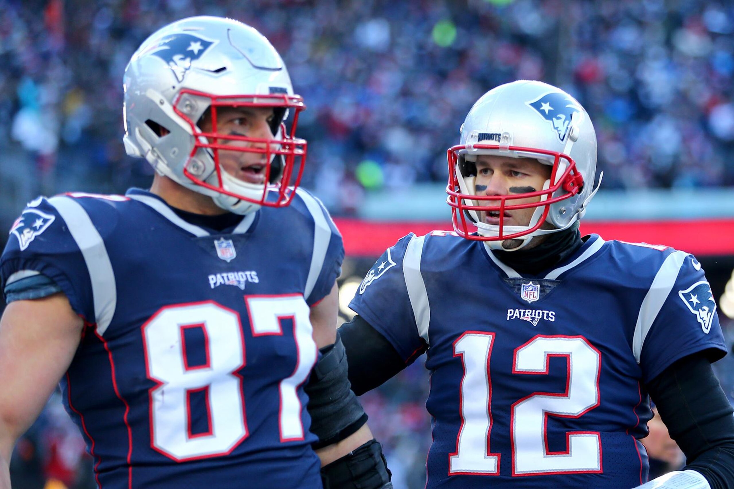 FOXBOROUGH, MASSACHUSETTS - JANUARY 13: Tom Brady #12 of the New England Patriots and Rob Gronkowski #87 react during the second quarter in the AFC Divisional Playoff Game against the Los Angeles Chargers at Gillette Stadium on January 13, 2019 in Foxborough, Massachusetts. (Photo by Adam Glanzman/Getty Images)