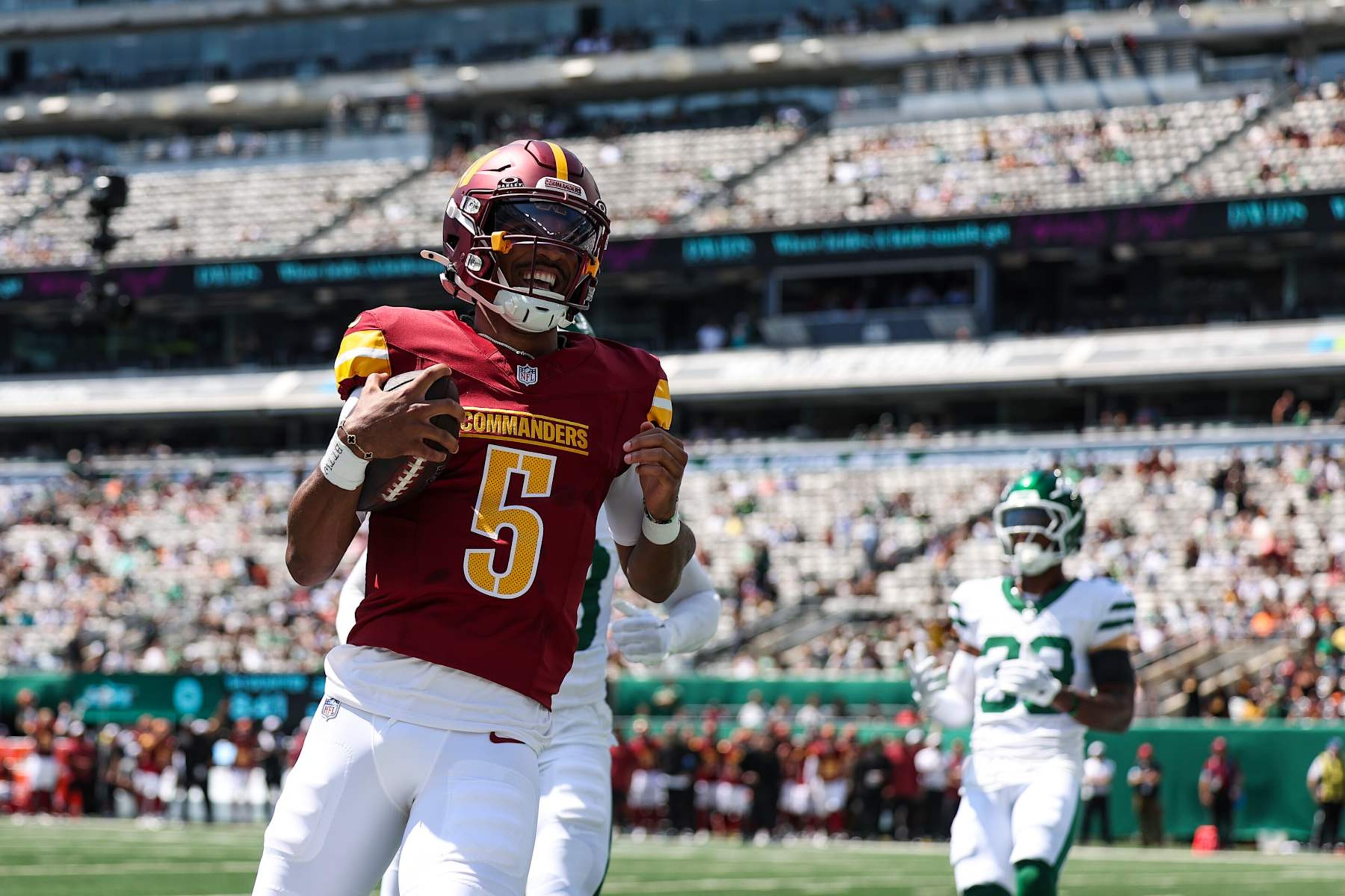 EAST RUTHERFORD, NJ - AUGUST 10: Jayden Daniels #5 of the Washington Commanders runs the ball for a touchdown during an NFL football game against the New York Jets at MetLife Stadium on August 10, 2024 in East Rutherford, NJ. (Photo by Perry Knotts/Getty Images)