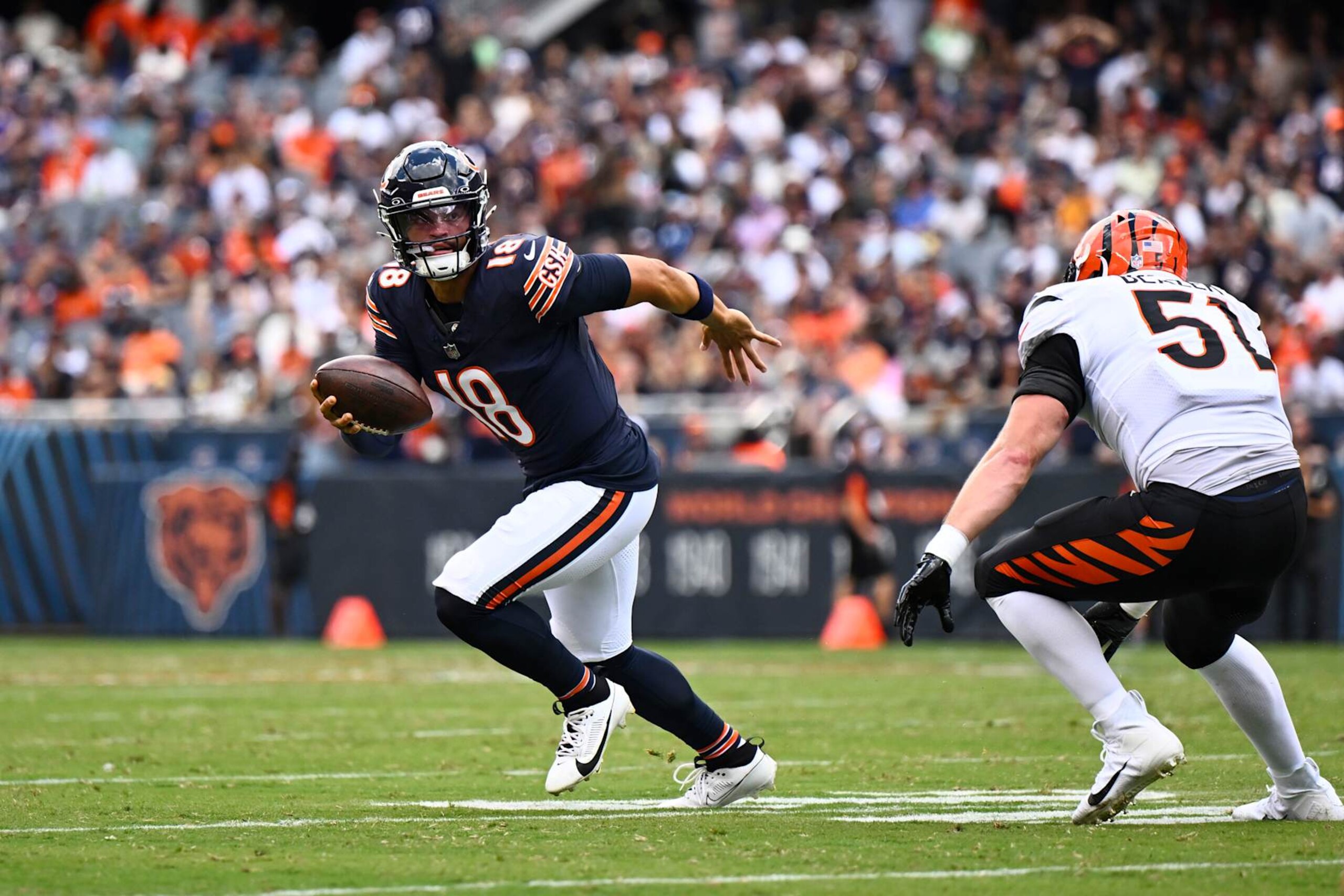 CHICAGO, ILLINOIS - AUGUST 17: Caleb Williams #18 of the Chicago Bears scrambles in the first half a preseason game against the Cincinnati Bengals at Soldier Field on August 17, 2024 in Chicago, Illinois. (Photo by Quinn Harris/Getty Images)