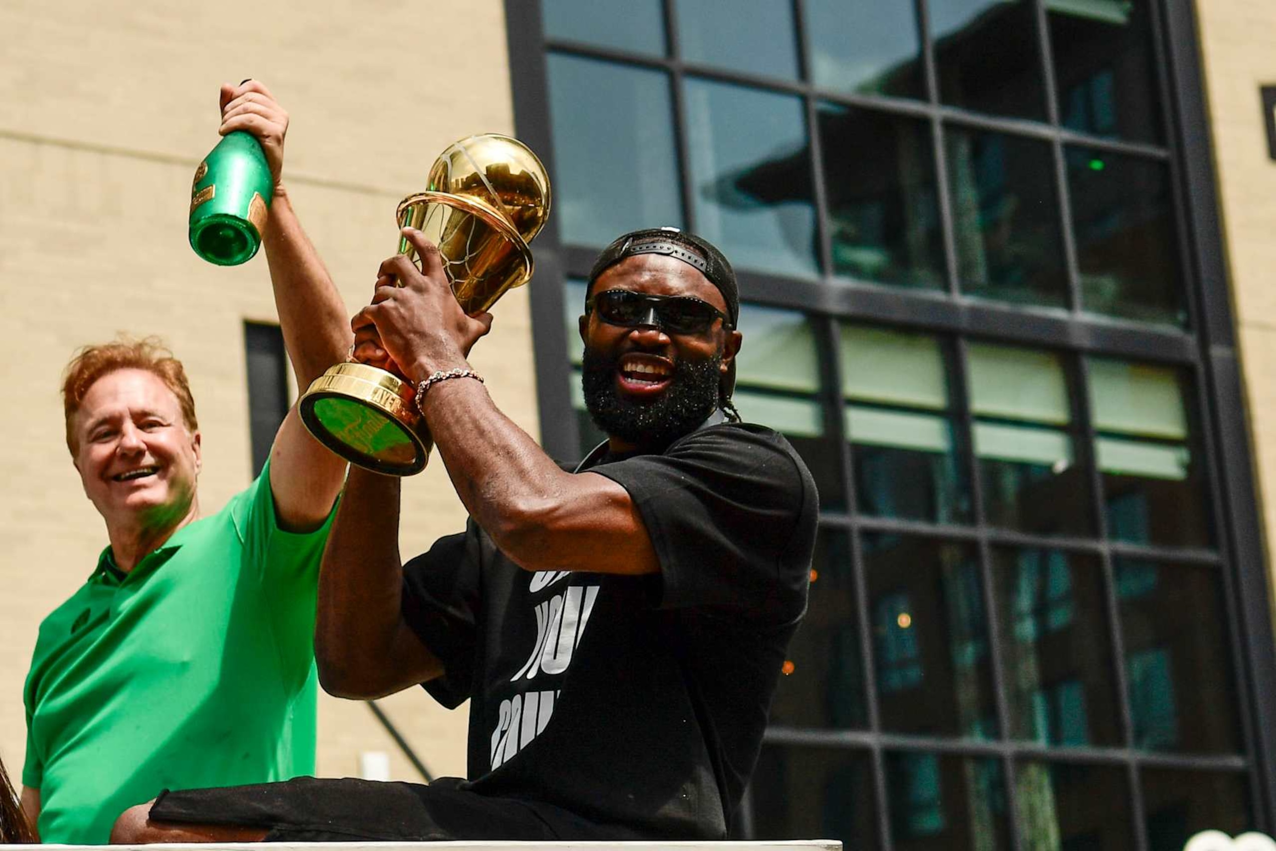BOSTON, MASSACHUSETTS - JUNE 21: Jaylen Brown #7 of the Boston Celtics reacts as he holds the NBA Finals Most Valuable Player trophy during the 2024 Boston Celtics championship parade following their 2024 NBA Finals win on June 21, 2024 in Boston, Massachusetts.  (Photo by Billie Weiss/Getty Images)