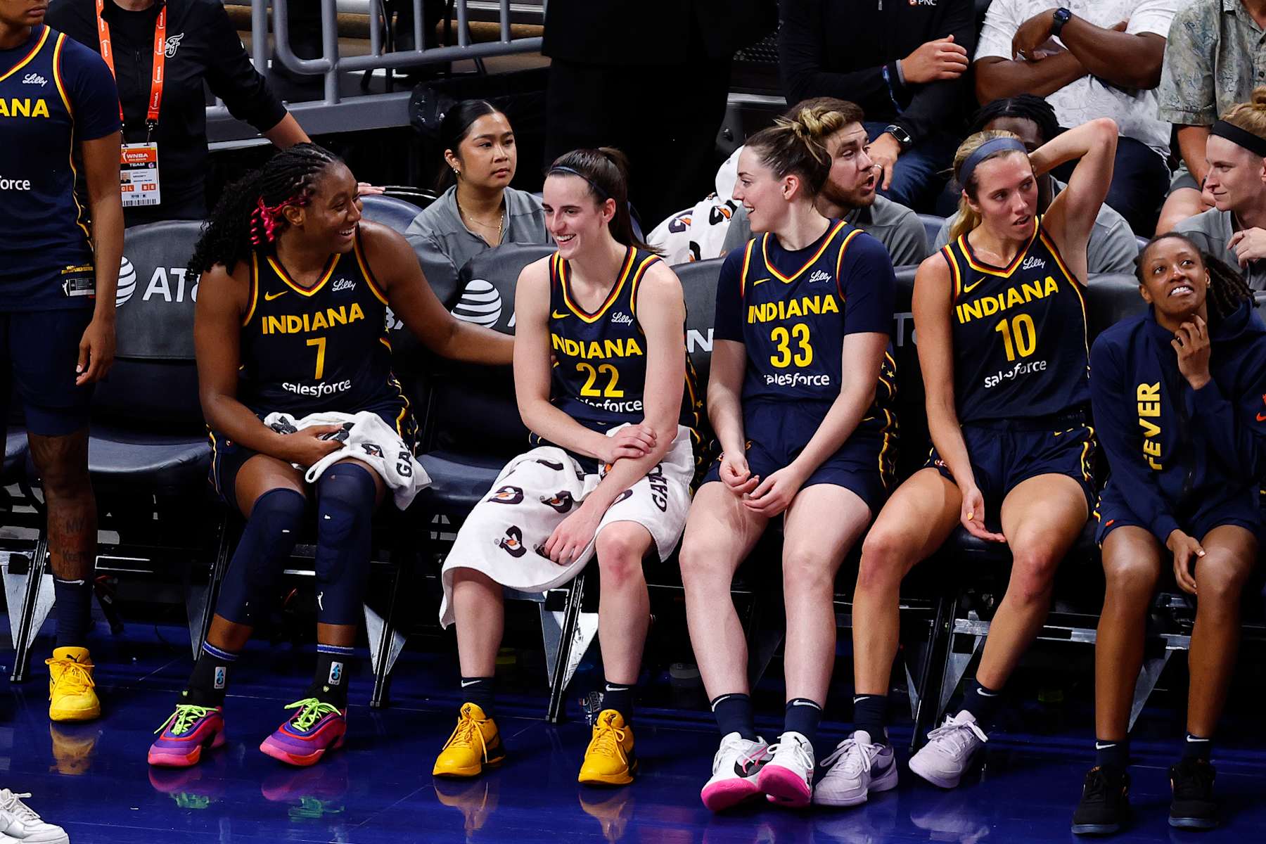 INDIANAPOLIS, IN - AUGUST 18: Indiana Fever forward Aliyah Boston (7) shares a laugh with Indiana Fever guard Caitlin Clark (22) on the bench in the closing minutes of the fourth quarter during a WNBA game between the Seattle Storm and the Indiana Fever on August 18, 2024 at Gainbridge Fieldhouse in Indianapolis, IN. (Photo by Jeffrey Brown/Icon Sportswire via Getty Images)