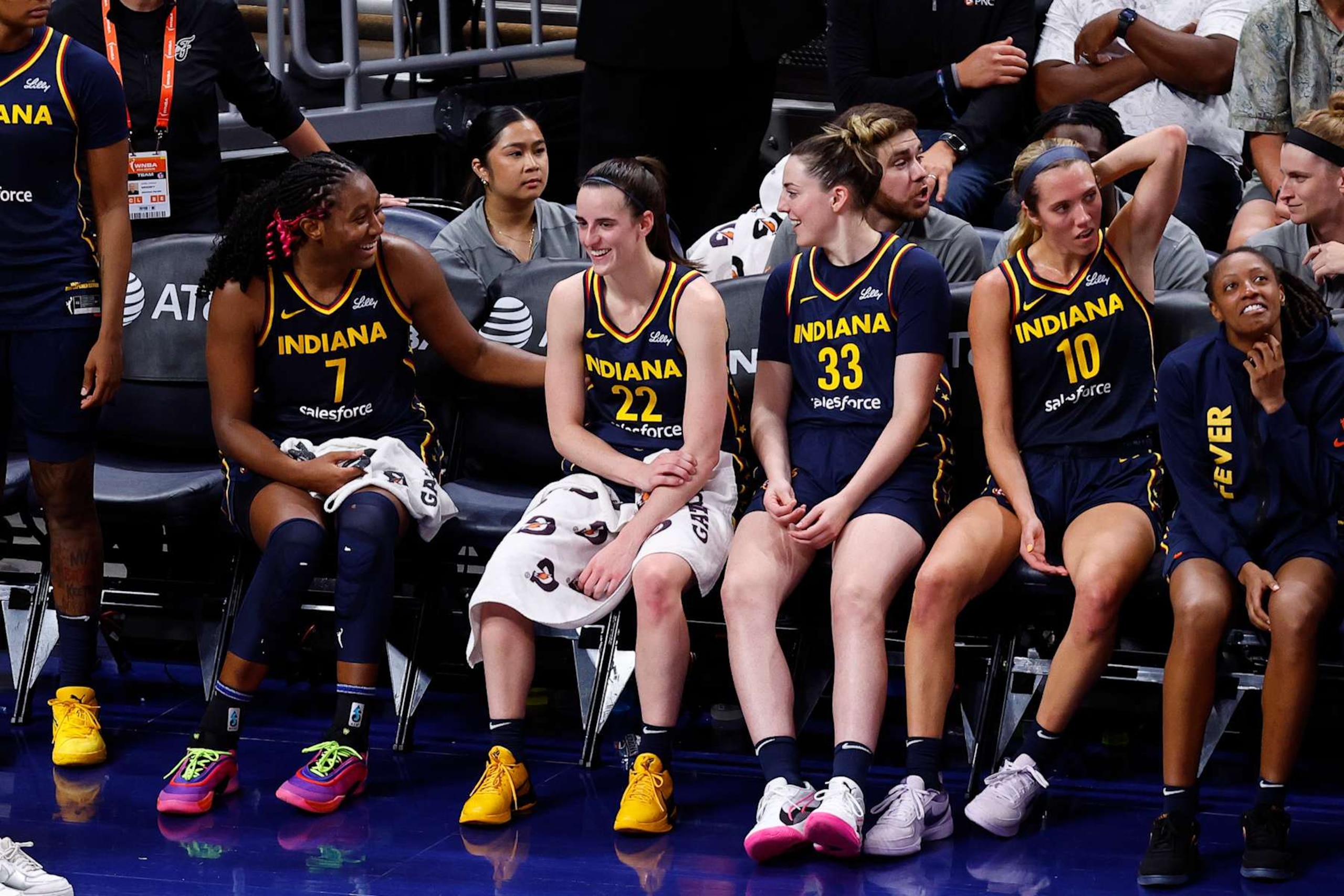 INDIANAPOLIS, IN - AUGUST 18: Indiana Fever forward Aliyah Boston (7) shares a laugh with Indiana Fever guard Caitlin Clark (22) on the bench in the closing minutes of the fourth quarter during a WNBA game between the Seattle Storm and the Indiana Fever on August 18, 2024 at Gainbridge Fieldhouse in Indianapolis, IN. (Photo by Jeffrey Brown/Icon Sportswire via Getty Images)