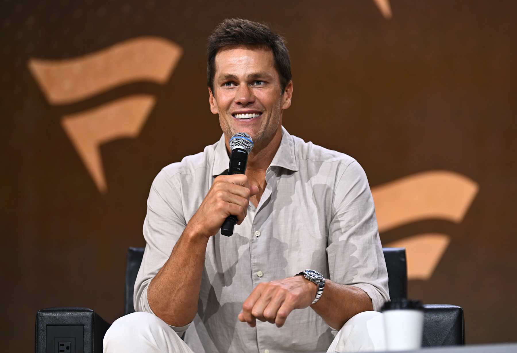 NEW YORK, NEW YORK - AUGUST 16: Tom Brady speaks at the Fanatics Fest NYC 2024 at Jacob Javits Center on August 16, 2024 in New York City.  (Photo by Roy Rochlin/Getty Images for Fanatics)