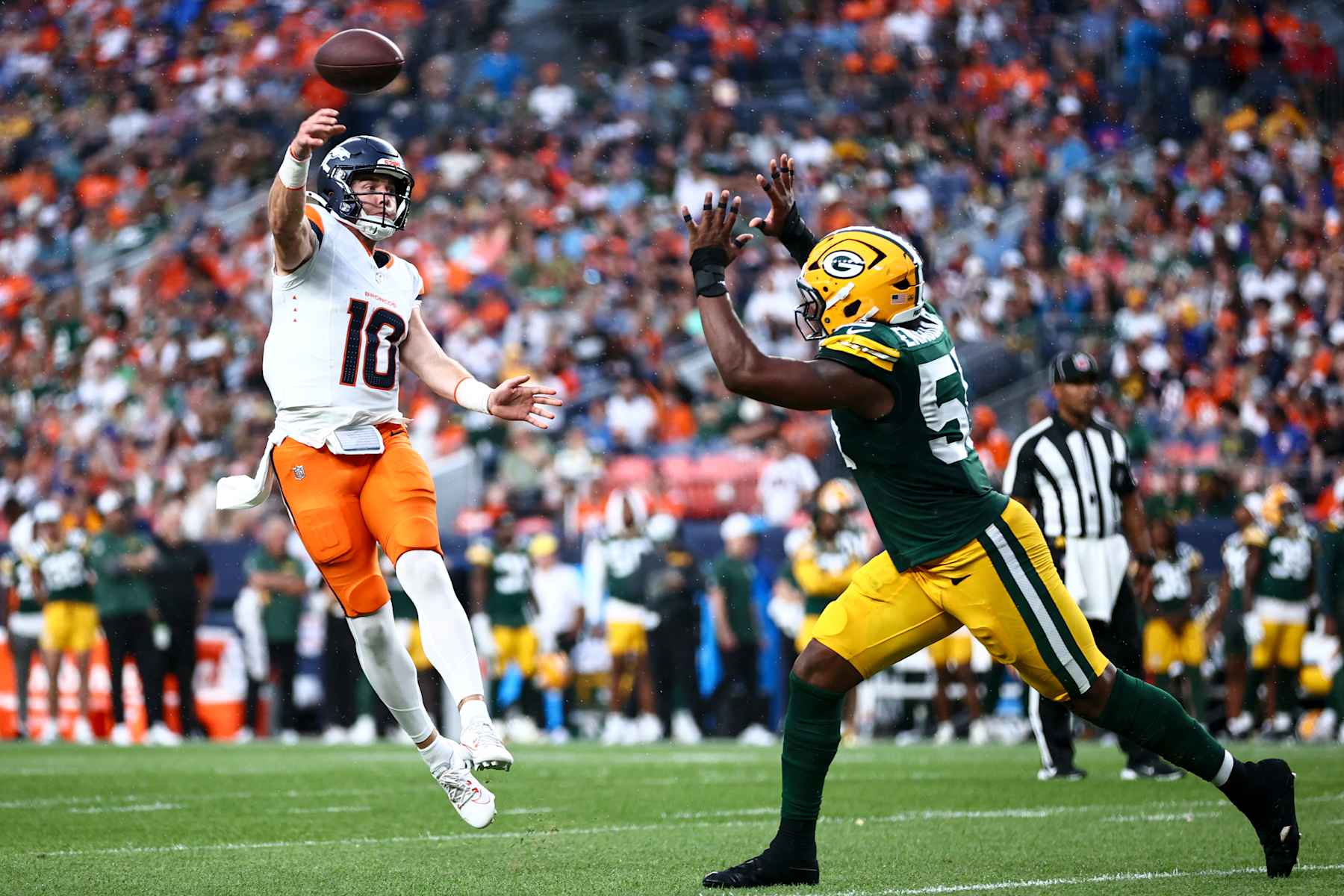 DENVER, COLORADO - AUGUST 18: Bo Nix #10 of the Denver Broncos throws a touchdown pass to Tim Patrick #12 in the second quarter during the preseason game against the Green Bay Packers at Empower Field At Mile High on August 18, 2024 in Denver, Colorado. (Photo by Tyler Schank/Getty Images) DENVER, COLORADO - AUGUST 18: Bo Nix #10 of the Denver Broncos throws a touchdown pass to Tim Patrick #12 in the second quarter during the preseason game against the Green Bay Packers at Empower Field At Mile High on August 18, 2024 in Denver, Colorado. (Photo by Tyler Schank/Getty Images)