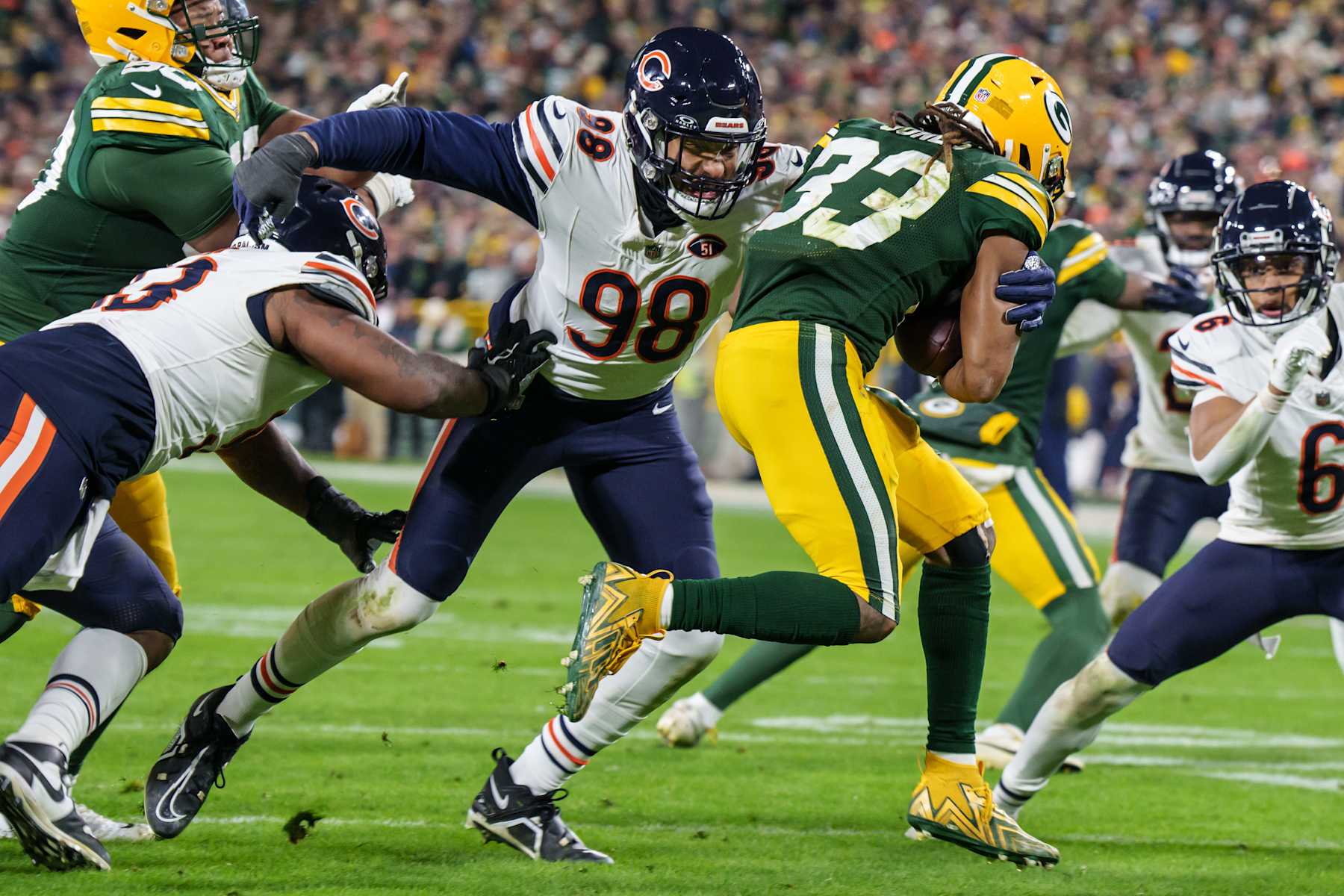 GREEN BAY, WI - JANUARY 7: Defensive End Montez Sweat #98 of the Chicago Bears pursues Running Back Aaron Jones #33 of the Green Bay Packers during the second half of an NFL football game at Lambeau Field on January 7, 2024 in Green Bay, Wisconsin. The Packers beat the Bears 17-9. (Photo by Todd Rosenberg/Getty Images)