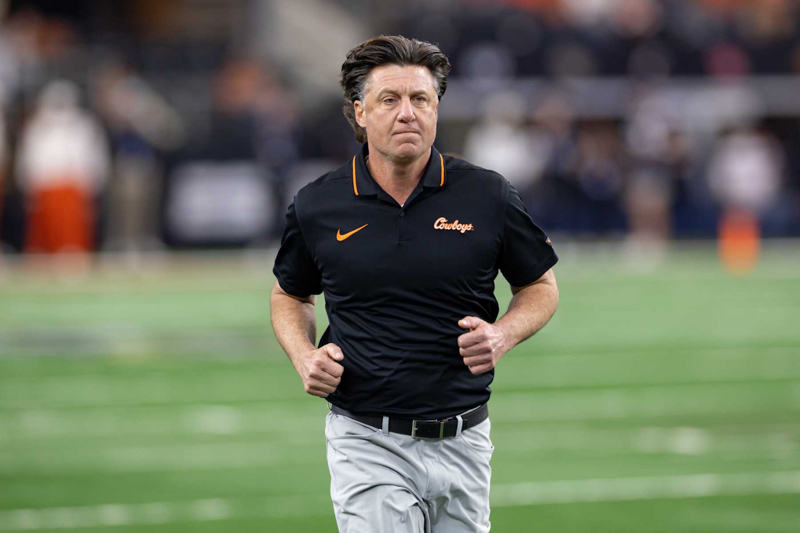 ARLINGTON, TX - DECEMBER 02: Oklahoma State Cowboys head coach Mike Gundy runs on to the field during the Big 12 Championship football game between the Texas Longhorns and Oklahoma State Cowboys on December 02, 2023 at AT&T Studium in Arlington, Texas. (Photo by Matthew Visinsky/Icon Sportswire via Getty Images)