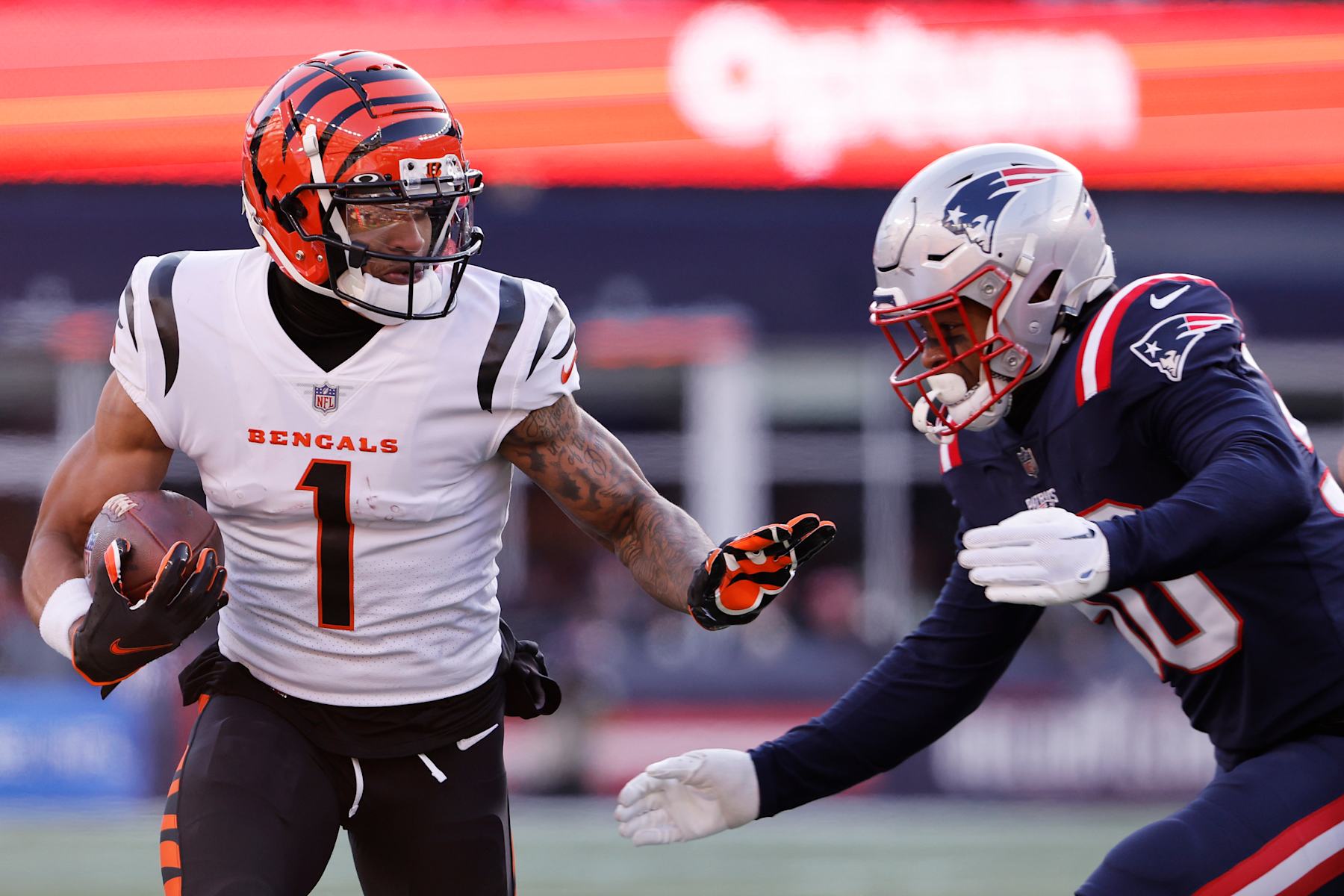 FOXBOROUGH, MASSACHUSETTS - DECEMBER 24: Raekwon McMillan #50 of the New England Patriots attempts to tackle Ja'Marr Chase #1 of the Cincinnati Bengals during the second quarter at Gillette Stadium on December 24, 2022 in Foxborough, Massachusetts. (Photo by Winslow Townson/Getty Images)