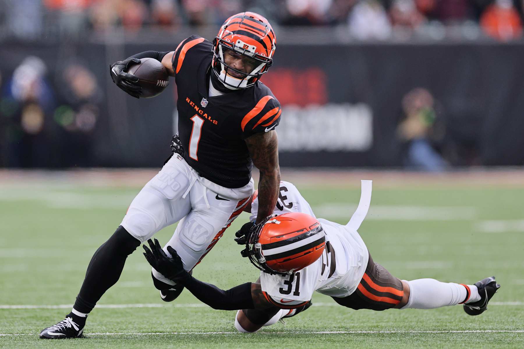 CINCINNATI, OHIO - JANUARY 07: Ja'Marr Chase #1 of the Cincinnati Bengals is tackled by Vincent Gray #31 of the Cleveland Browns at Paycor Stadium on January 07, 2024 in Cincinnati, Ohio. (Photo by Andy Lyons/Getty Images)