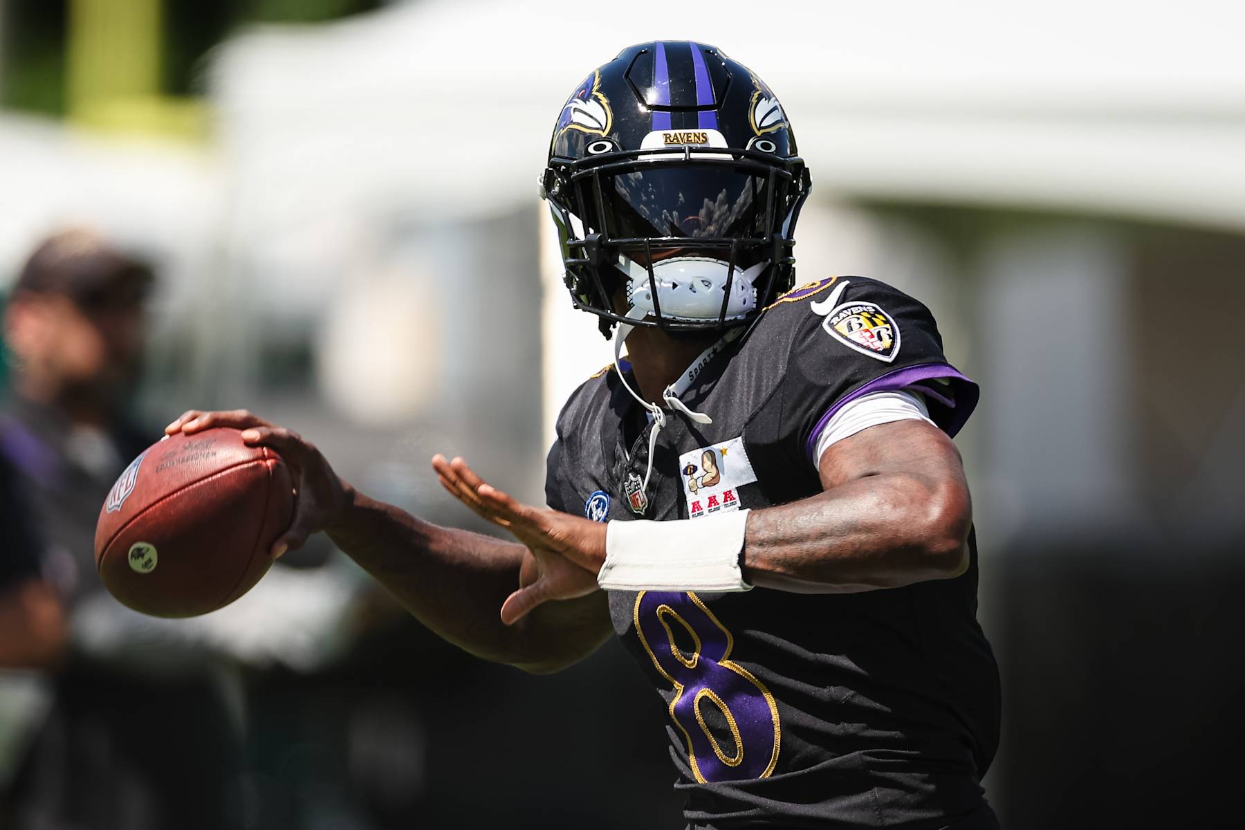 OWINGS MILLS, MD - AUGUST 12: Lamar Jackson #8 of the Baltimore Ravens attempts a pass during training camp at Under Armour Performance Center Baltimore Ravens on August 12, 2024 in Owings Mills, Maryland. (Photo by Scott Taetsch/Getty Images)