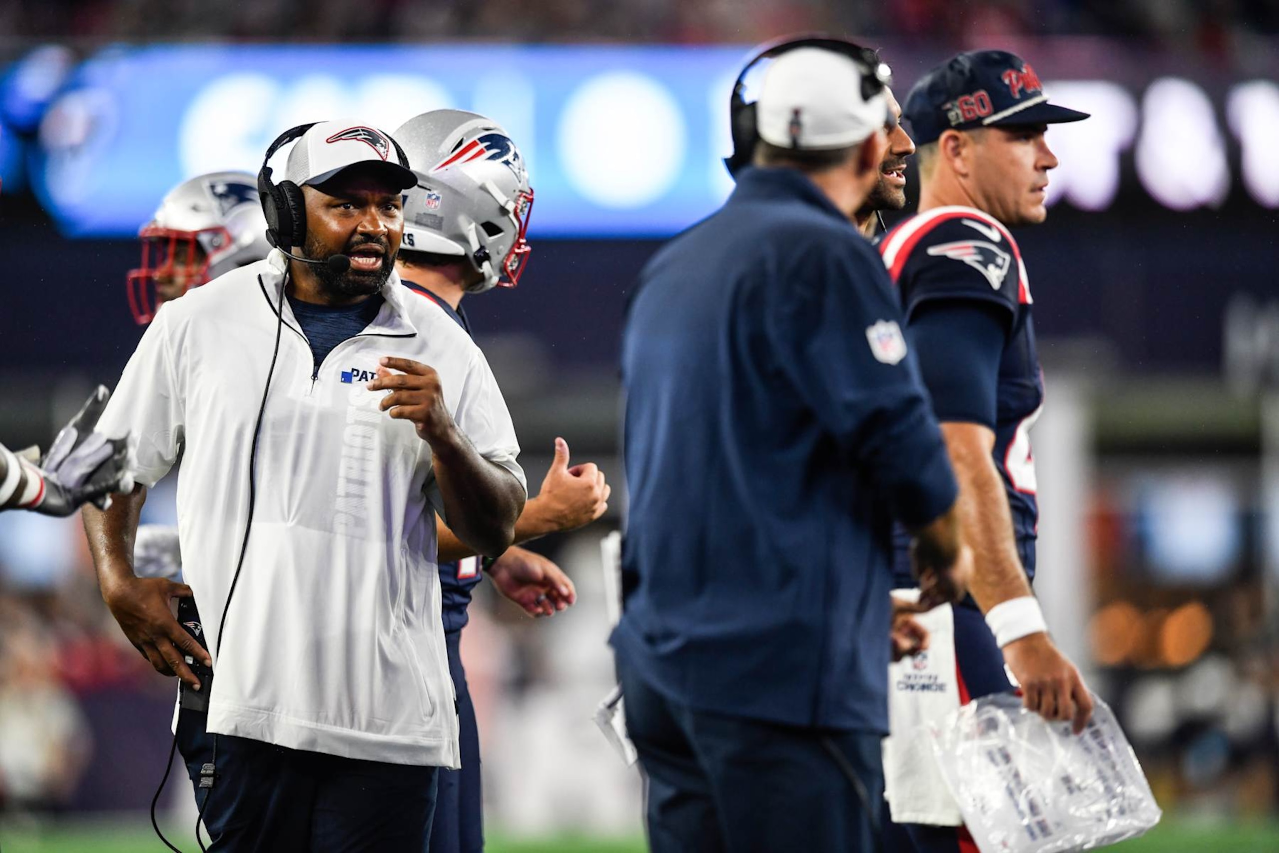 FOXBOROUGH, MASSACHUSETTS - AUGUST 08: Head coach of the Jerod Mayo speaks to his staff during the second quarter of a  preseason game against the Carolina Panthers at Gillette Stadium on August 08, 2024 in Foxborough, Massachusetts. (Photo by Jaiden Tripi/Getty Images)