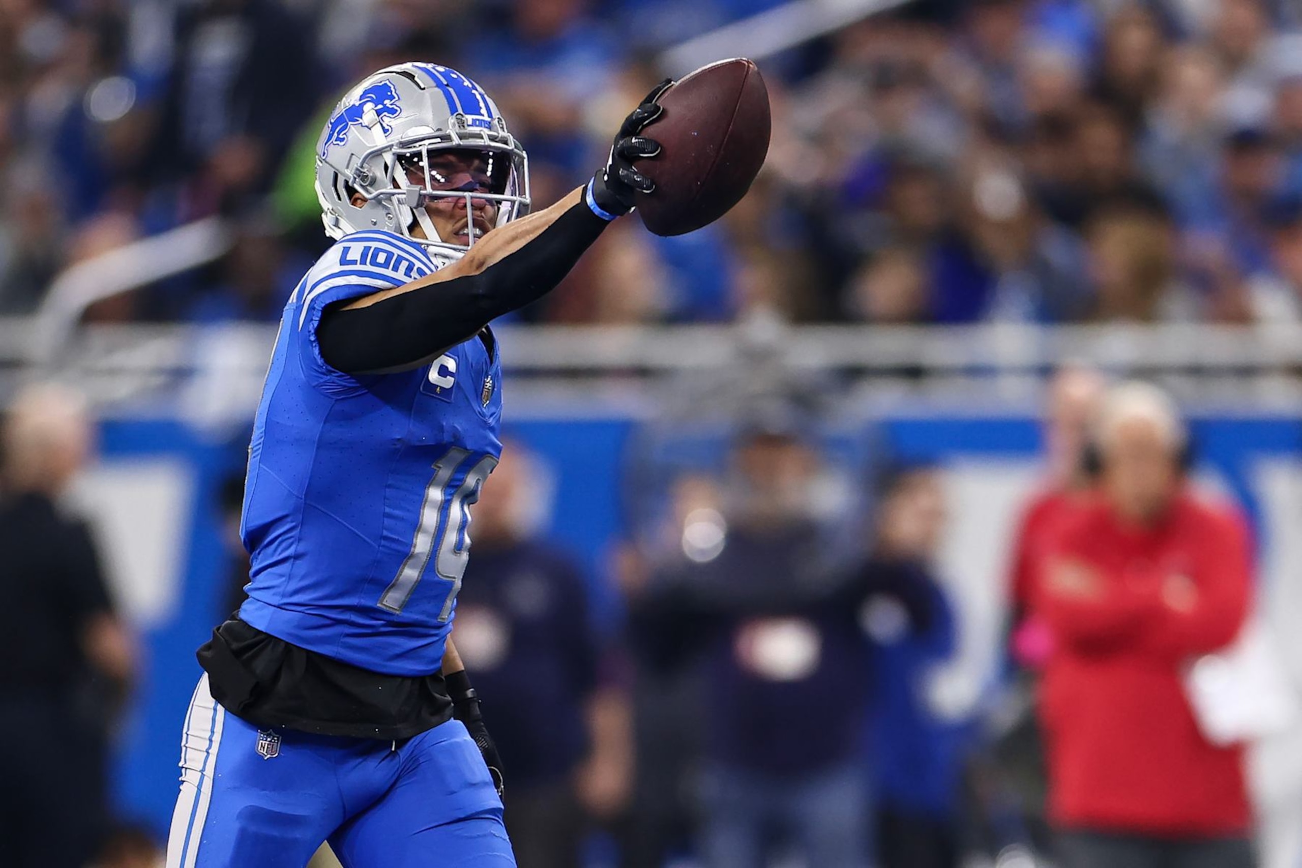 DETROIT, MI - JANUARY 21: Amon-Ra St. Brown #14 of the Detroit Lions celebrates after a play during the first quarter of an NFL divisional round playoff football game against the Tampa Bay Buccaneers at Ford Field on January 21, 2024 in Detroit, Michigan. (Photo by Kevin Sabitus/Getty Images)