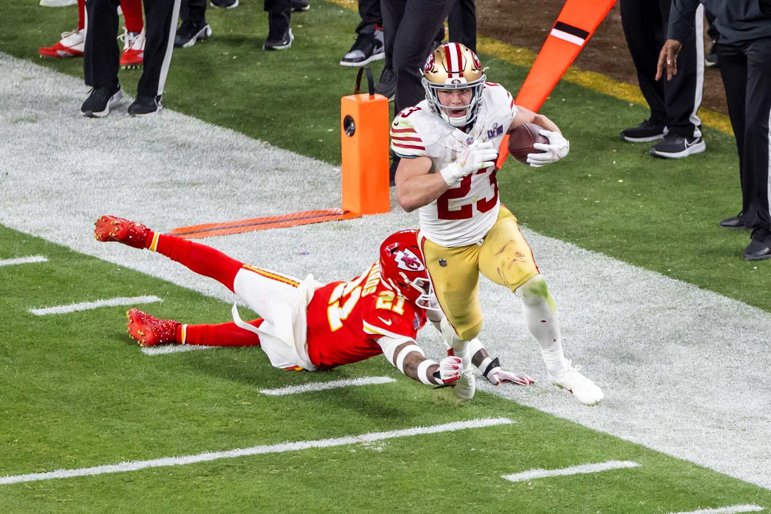 LAS VEGAS, NV - FEBRUARY 11: San Francisco 49ers running back Christian McCaffrey (23) runs through the tackle attempt of Kansas City Chiefs safety Mike Edwards (21) during Super Bowl LVIII between the Kansas City Chiefs and the San Francisco 49ers on Sunday February 11, 2024 at Allegiant Stadium in Las Vegas, NV.  (Photo by Nick Tre. Smith/Icon Sportswire via Getty Images)