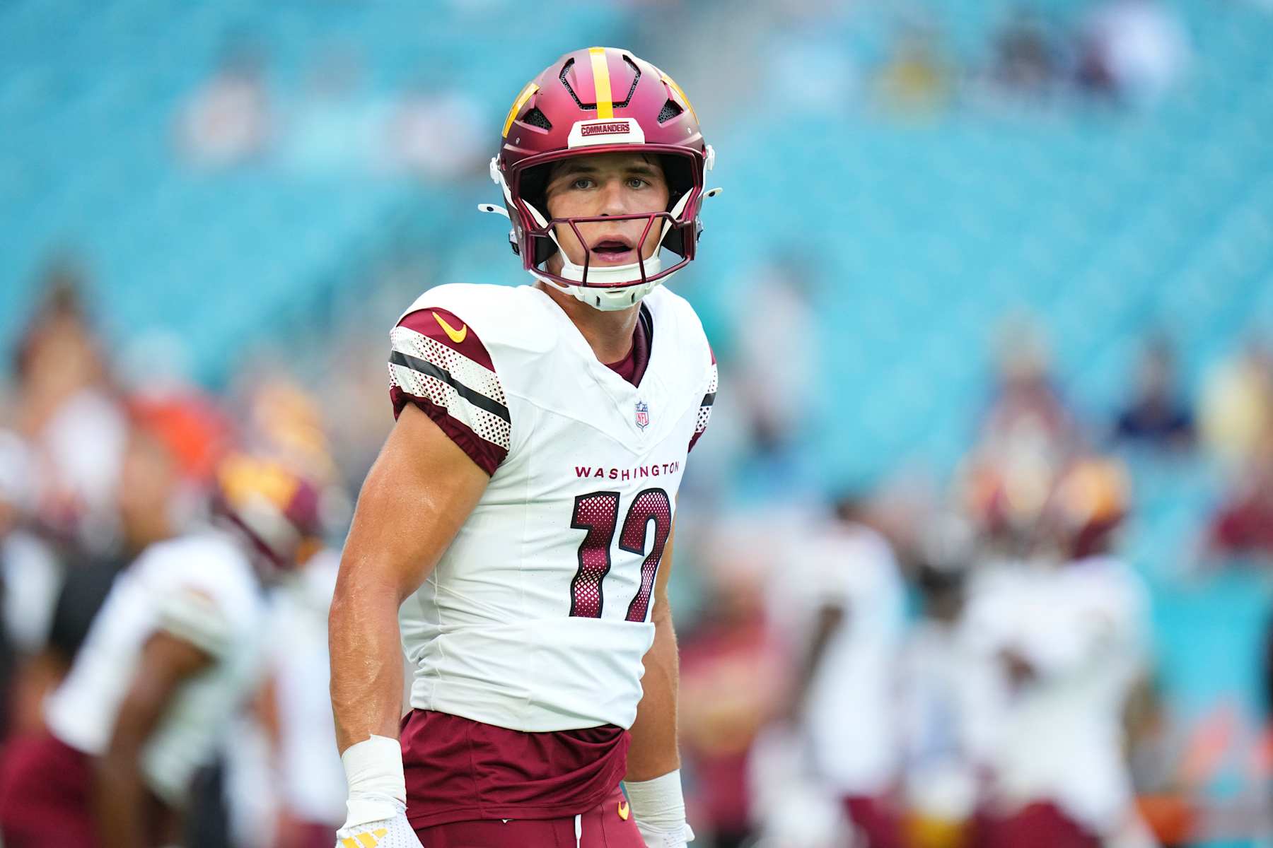 MIAMI GARDENS, FLORIDA - AUGUST 17: Luke McCaffrey #12 of the Washington Commanders warms up prior to a preseason game against the Miami Dolphins at Hard Rock Stadium on August 17, 2024 in Miami Gardens, Florida.  (Photo by Rich Storry/Getty Images)