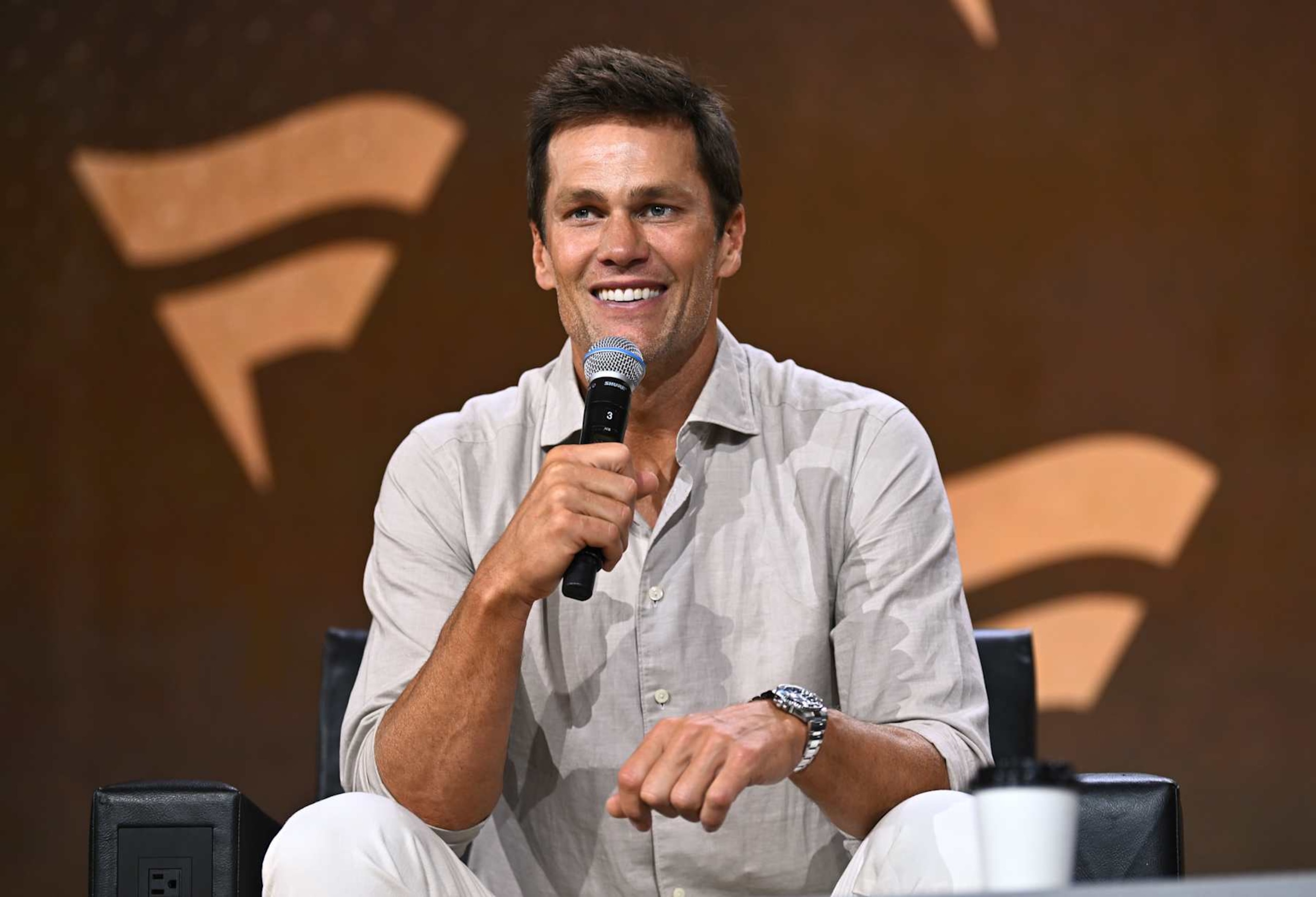 NEW YORK, NEW YORK - AUGUST 16: Tom Brady speaks at the Fanatics Fest NYC 2024 at Jacob Javits Center on August 16, 2024 in New York City. (Photo by Roy Rochlin/Getty Images for Fanatics) NEW YORK, NEW YORK - AUGUST 16: Tom Brady speaks at the Fanatics Fest NYC 2024 at Jacob Javits Center on August 16, 2024 in New York City. (Photo by Roy Rochlin/Getty Images for Fanatics)