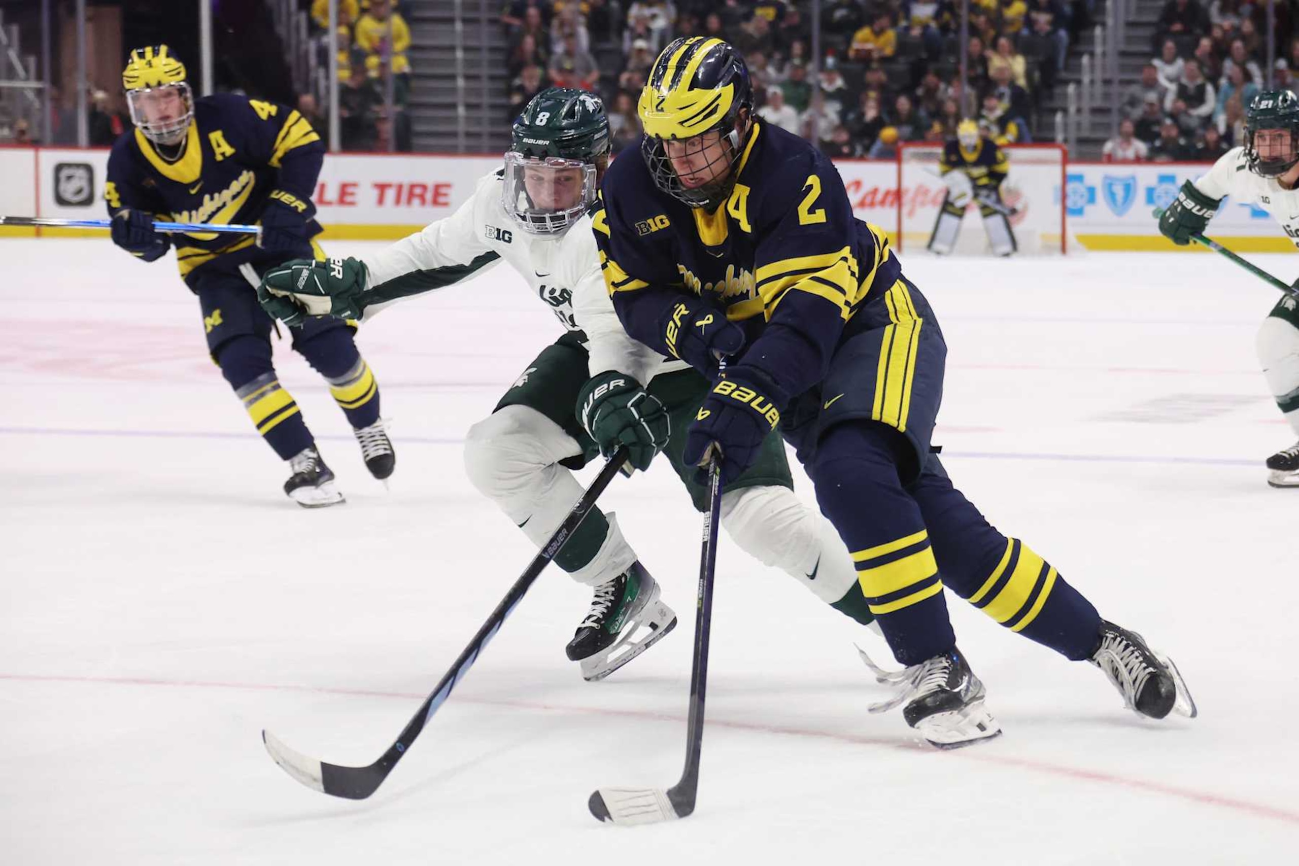 DETROIT, MICHIGAN - FEBRUARY 10: Rutger McGroarty #2 of the Michigan Wolverines tries to get around Maxim Štrbák #8 of the Michigan St. Spartans during the first period at Little Caesars Arena on February 10, 2024 in Detroit, Michigan. (Photo by Gregory Shamus/Getty Images)