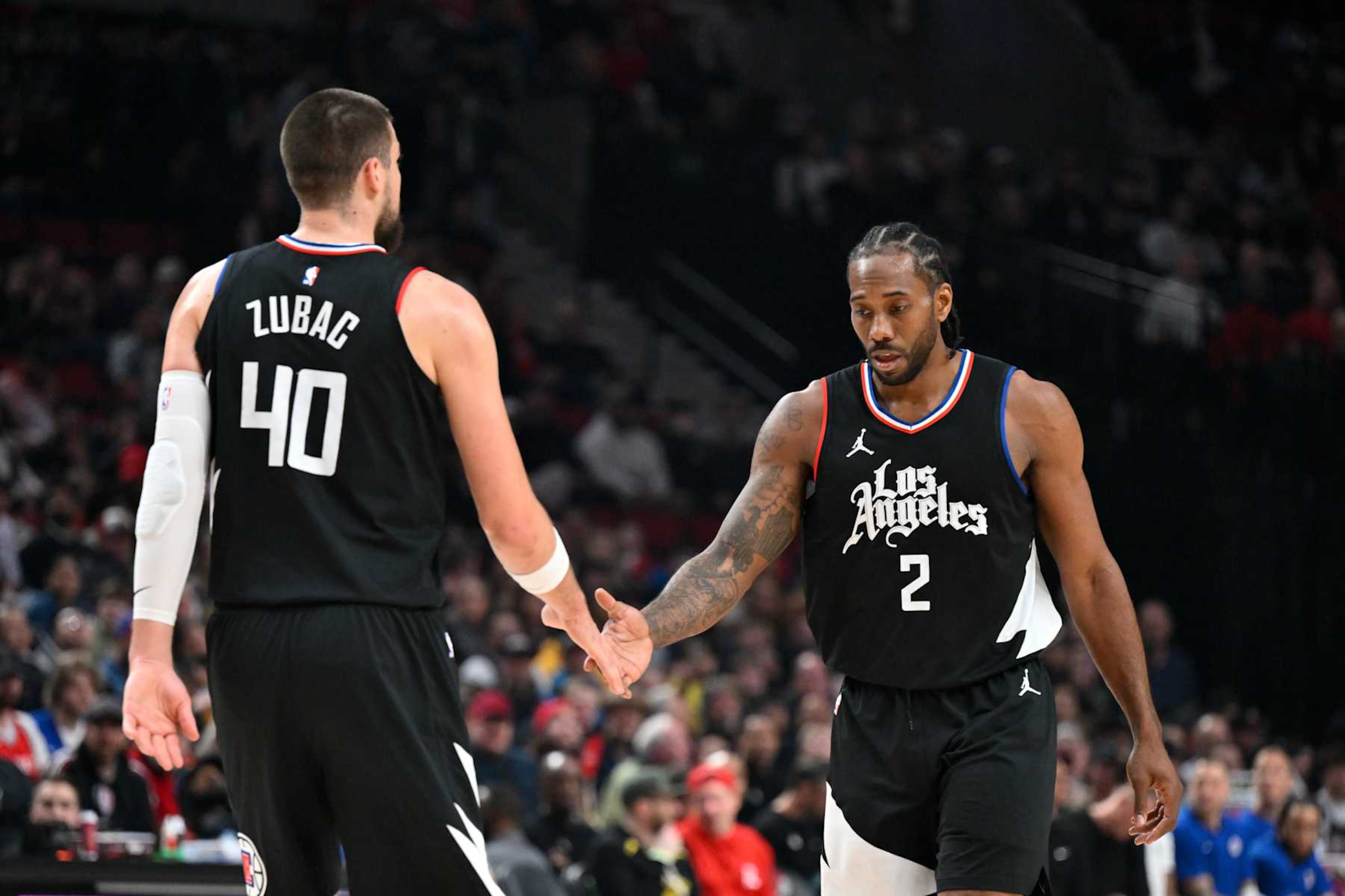 PORTLAND, OREGON - MARCH 22: Kawhi Leonard #2 of the LA Clippers and Ivica Zubac #40 shake hands during the first quarter of the game against the Portland Trail Blazers at the Moda Center on March 22, 2024 in Portland, Oregon. NOTE TO USER: User expressly acknowledges and agrees that, by downloading and or using this photograph, User is consenting to the terms and conditions of the Getty Images License Agreement. (Photo by Alika Jenner/Getty Images) PORTLAND, OREGON - MARCH 22: Kawhi Leonard #2 of the LA Clippers and Ivica Zubac #40 shake hands during the first quarter of the game against the Portland Trail Blazers at the Moda Center on March 22, 2024 in Portland, Oregon. NOTE TO USER: User expressly acknowledges and agrees that, by downloading and or using this photograph, User is consenting to the terms and conditions of the Getty Images License Agreement. (Photo by Alika Jenner/Getty Images)