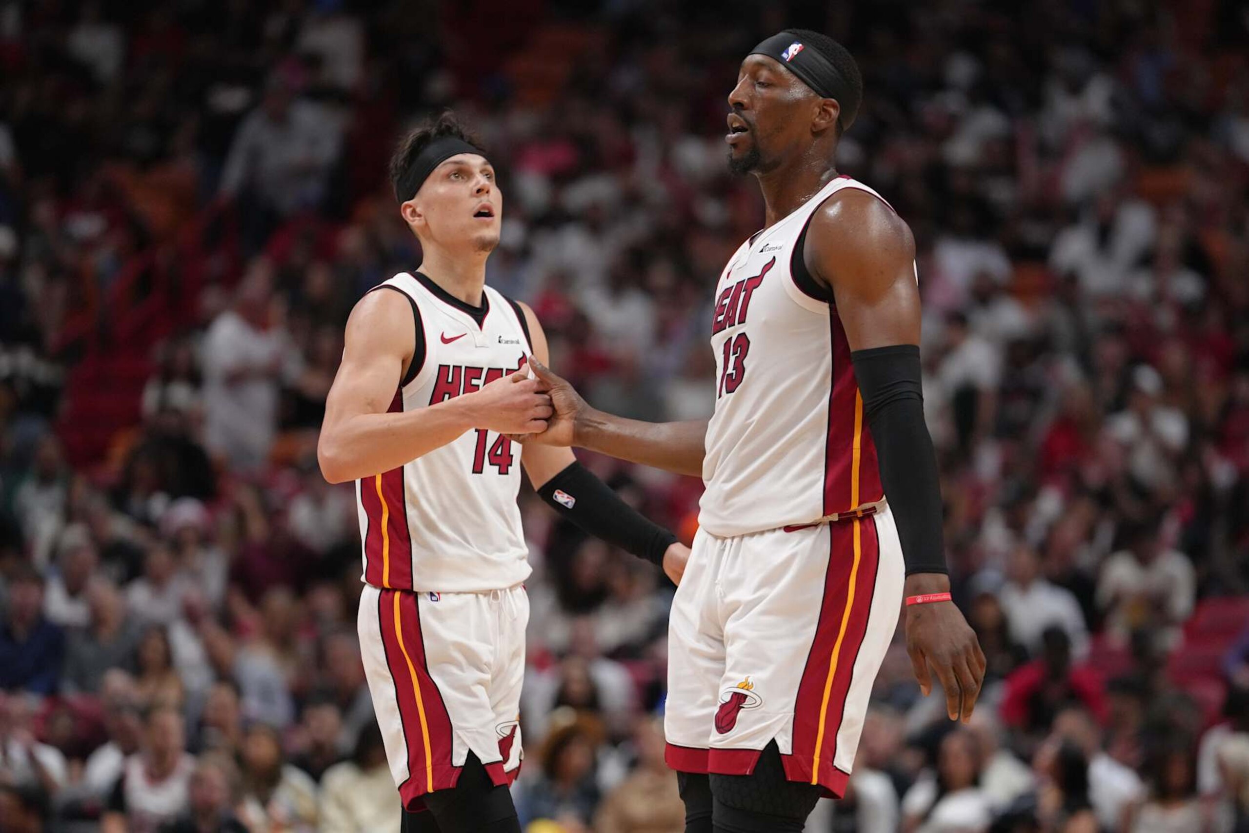MIAMI, FL - APRIL 19: Tyler Herro #14 and Bam Adebayo #13 of the Miami Heat shake hands during the game against the Chicago Bulls during the 2024 SoFi Play-In Tournament on April 19, 2024 at Kaseya Center in Miami, Florida. NOTE TO USER: User expressly acknowledges and agrees that, by downloading and or using this Photograph, user is consenting to the terms and conditions of the Getty Images License Agreement. Mandatory Copyright Notice: Copyright 2024 NBAE (Photo by Eric Espada/NBAE via Getty Images)