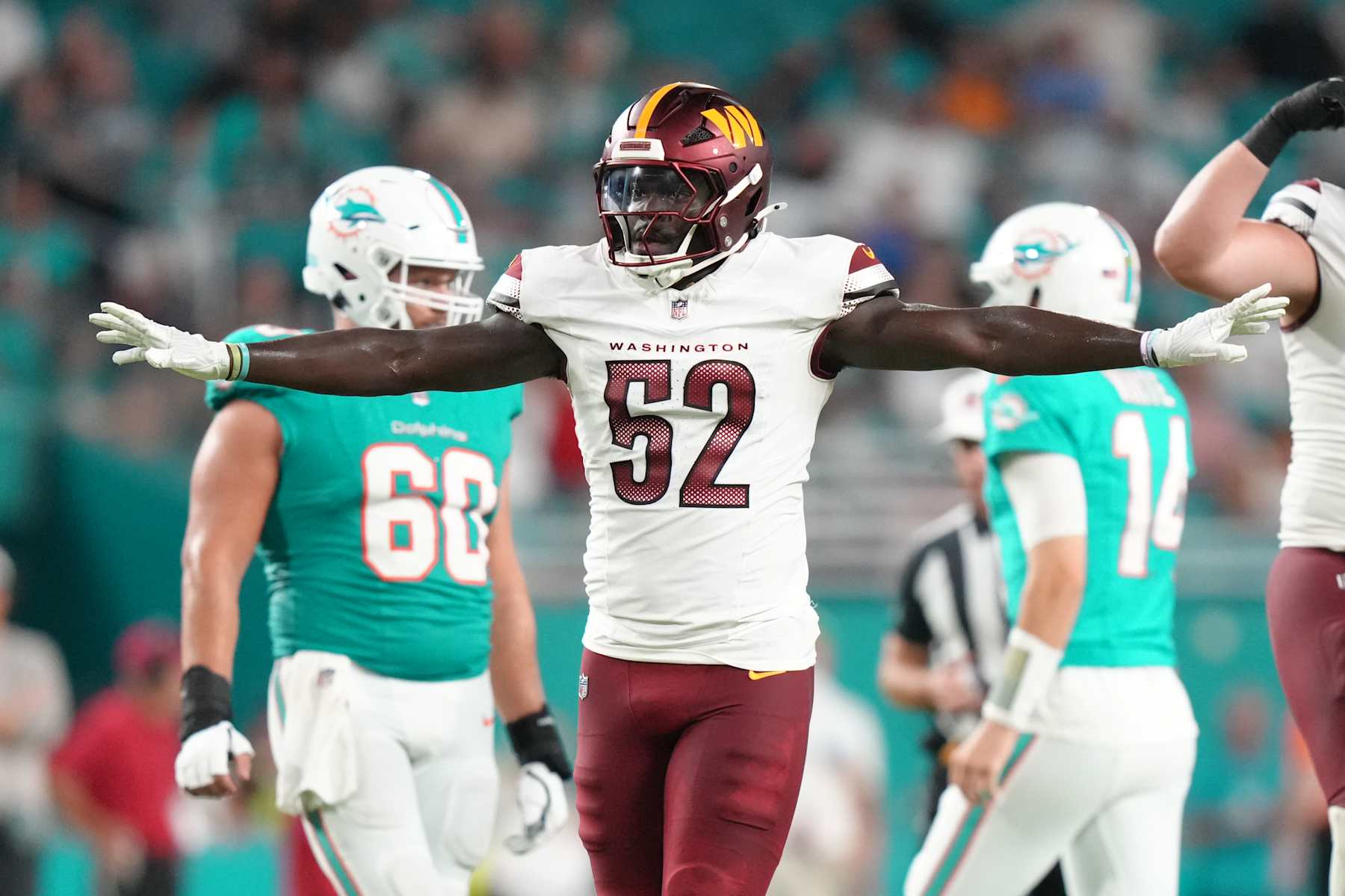 MIAMI GARDENS, FL - AUGUST 17: Washington Commanders linebacker Jamin Davis (52) celebrates a defensive stop during the game between the Washington Commanders and the Miami Dolphins on Saturday, August 17, 2024 at Hard Rock Stadium in Miami Gardens, Fla. (Photo by Peter Joneleit/Icon Sportswire via Getty Images)