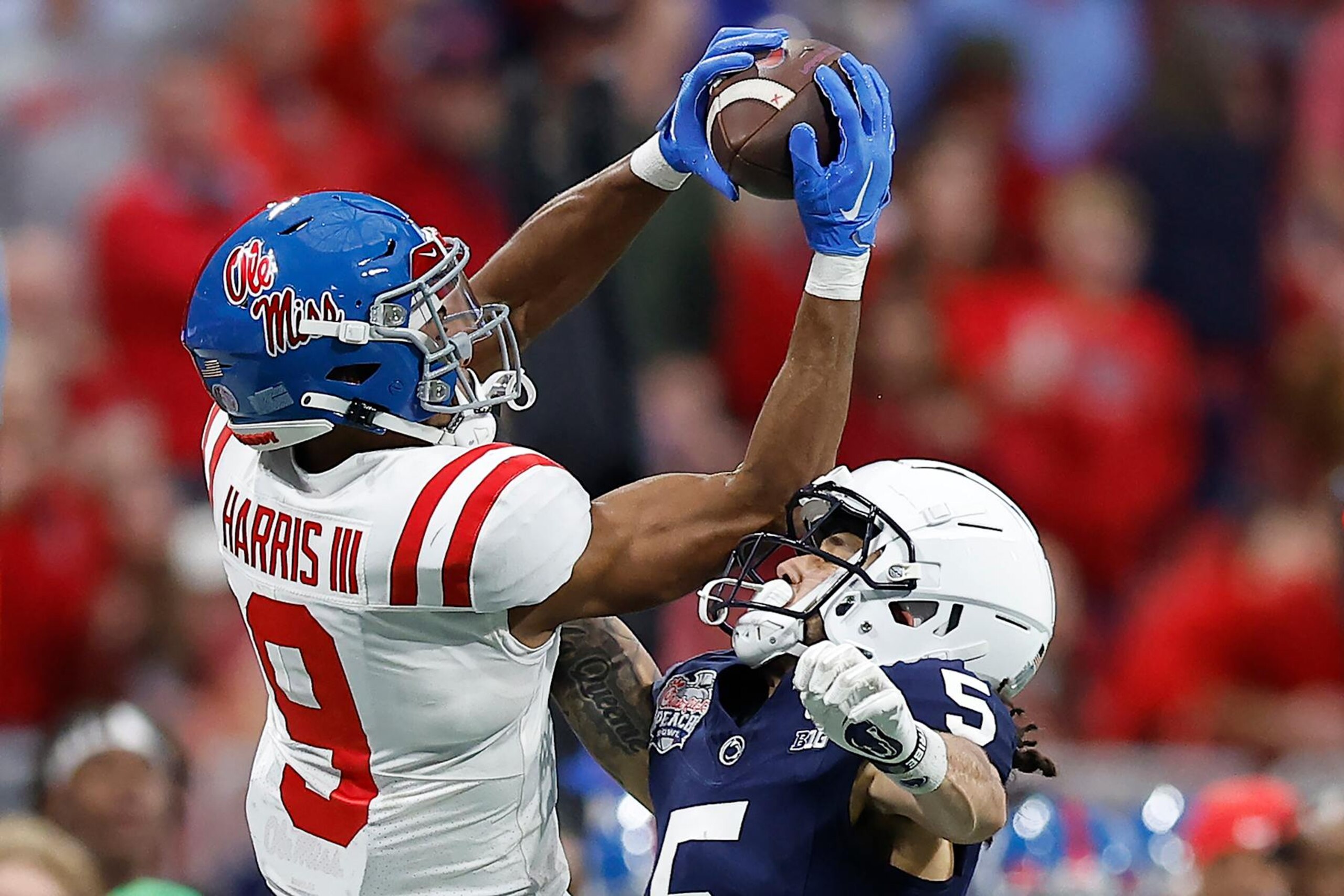 ATLANTA, GEORGIA - DECEMBER 30: Tre Harris #9 of the Mississippi Rebels catches a pass, which was later ruled incomplete, as Cam Miller #5 of the Penn State Nittany Lions pressures during the second quarter in the Chick-fil-A Peach Bowl at Mercedes-Benz Stadium on December 30, 2023 in Atlanta, Georgia. (Photo by Alex Slitz/Getty Images)