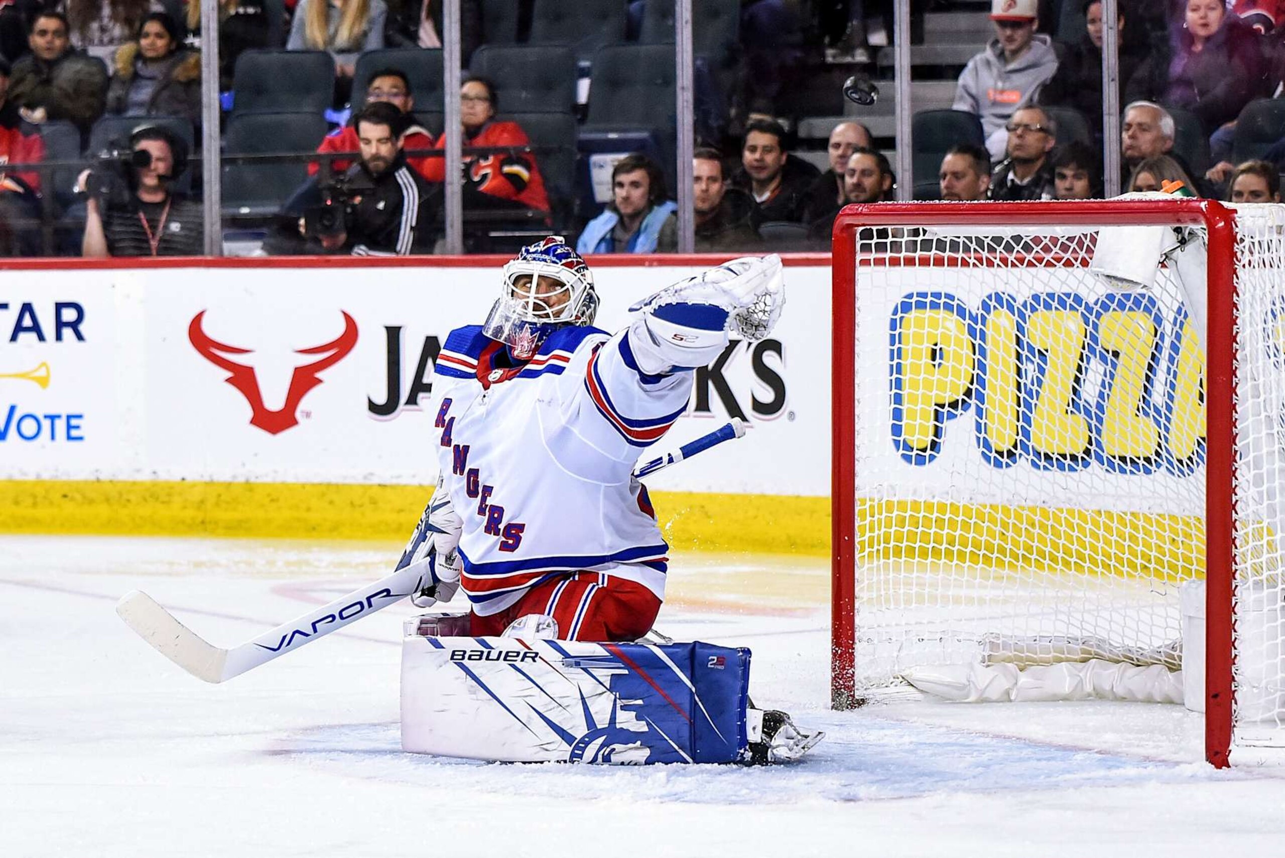 CALGARY, AB - JANUARY 02: New York Rangers Goalie Henrik Lundqvist (30) makes a glove save but cant hang onto the puck during the third period of an NHL game where the Calgary Flames hosted the New York Rangers on January 2, 2020, at the Scotiabank Saddledome in Calgary, AB. (Photo by Brett Holmes/Icon Sportswire via Getty Images)