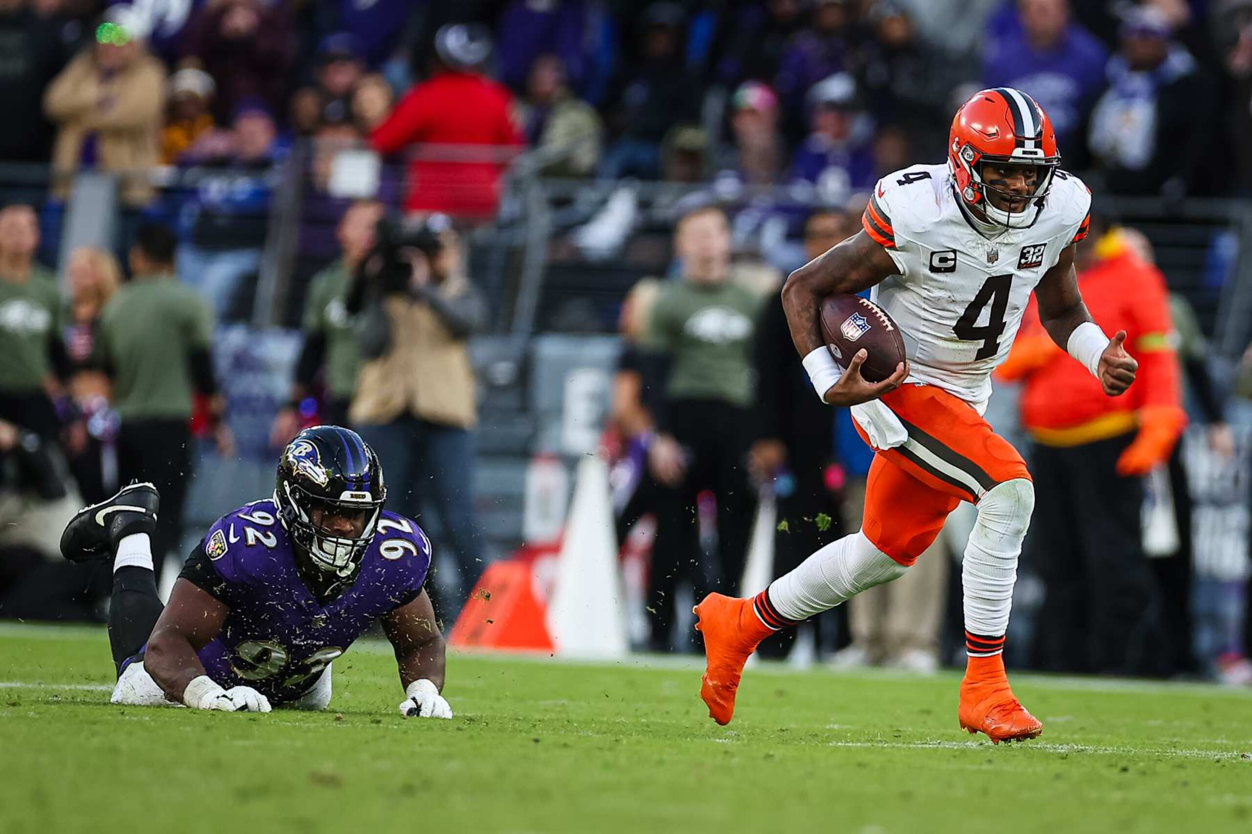 BALTIMORE, MD - NOVEMBER 12: Deshaun Watson #4 of the Cleveland Browns scrambles to avoid the tackle of Justin Madubuike #92 of the Baltimore Ravens during the second half at M&T Bank Stadium on November 12, 2023 in Baltimore, Maryland. (Photo by Scott Taetsch/Getty Images)