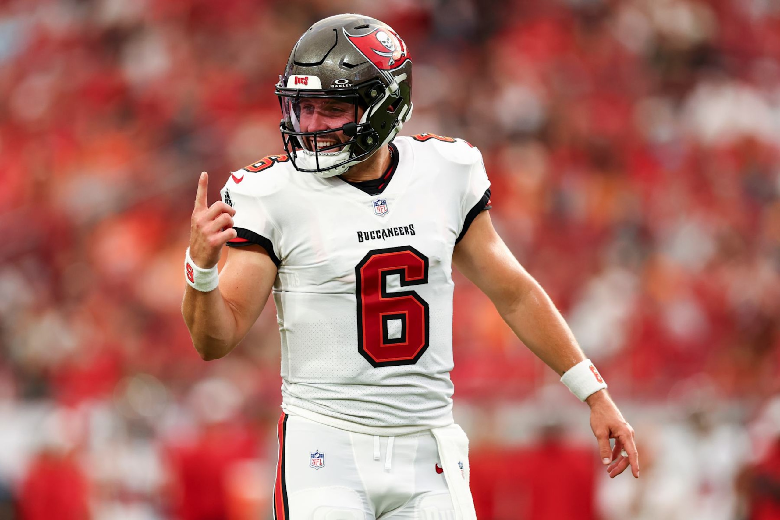 TAMPA, FL - AUGUST 23: Baker Mayfield #6 of the Tampa Bay Buccaneers smiles after a play during the first quarter of an NFL preseason football game against the Miami Dolphins at Raymond James Stadium on August 23, 2024 in Tampa, Florida. (Photo by Kevin Sabitus/Getty Images)