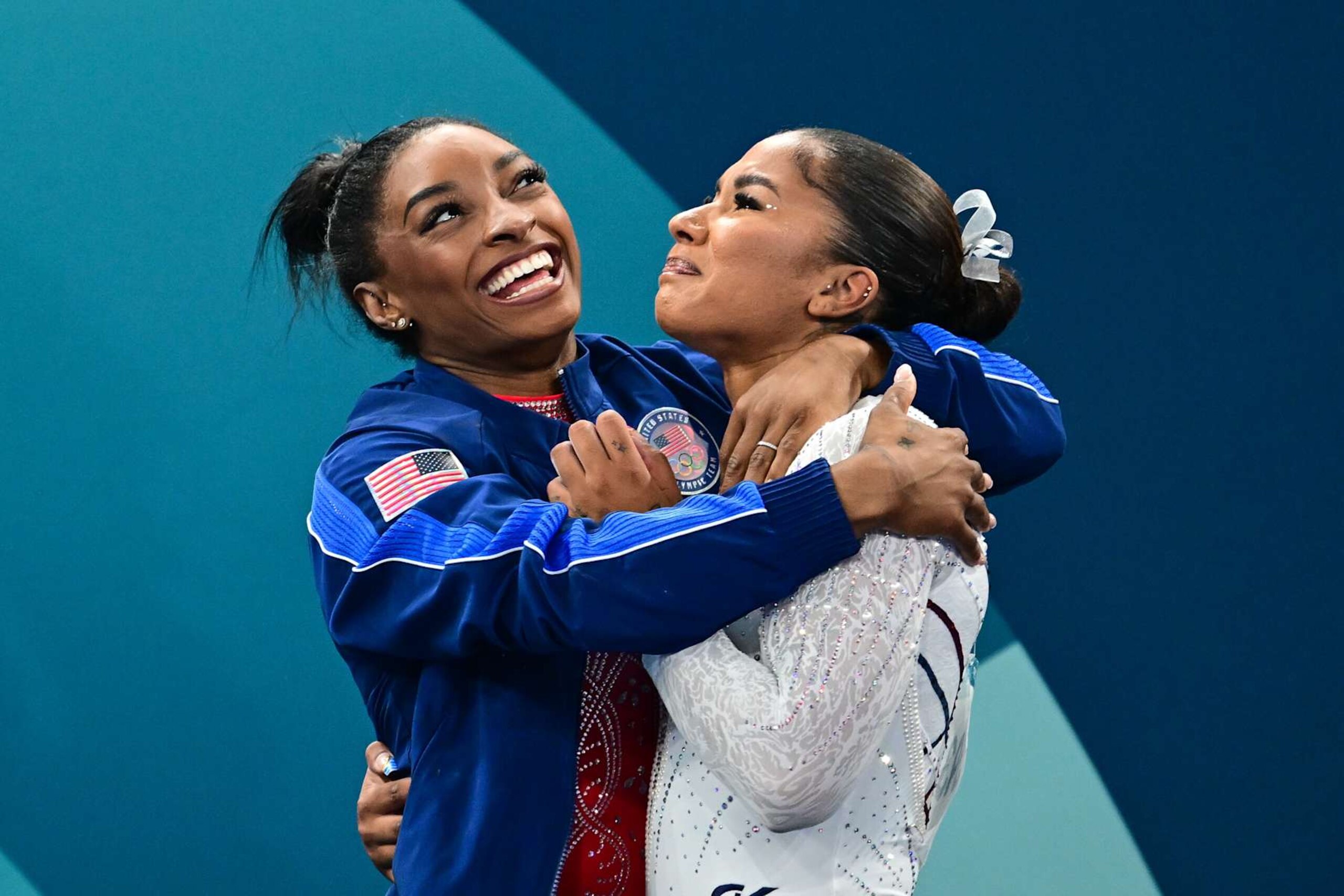 PARIS, FRANCE: AUGUST 05: Jordan Chiles of the United States is congratulated by teammate Simone Biles (L) of the United States after dramatically claiming the bronze medal on a score change after the Women's Floor Final during the Artistic Gymnastics competition at the Bercy Arena during the Paris 2024 Summer Olympic Games on August 5th, 2024 in Paris, France. (Photo by Mehmet Murat Onel/Anadolu via Getty Images)
