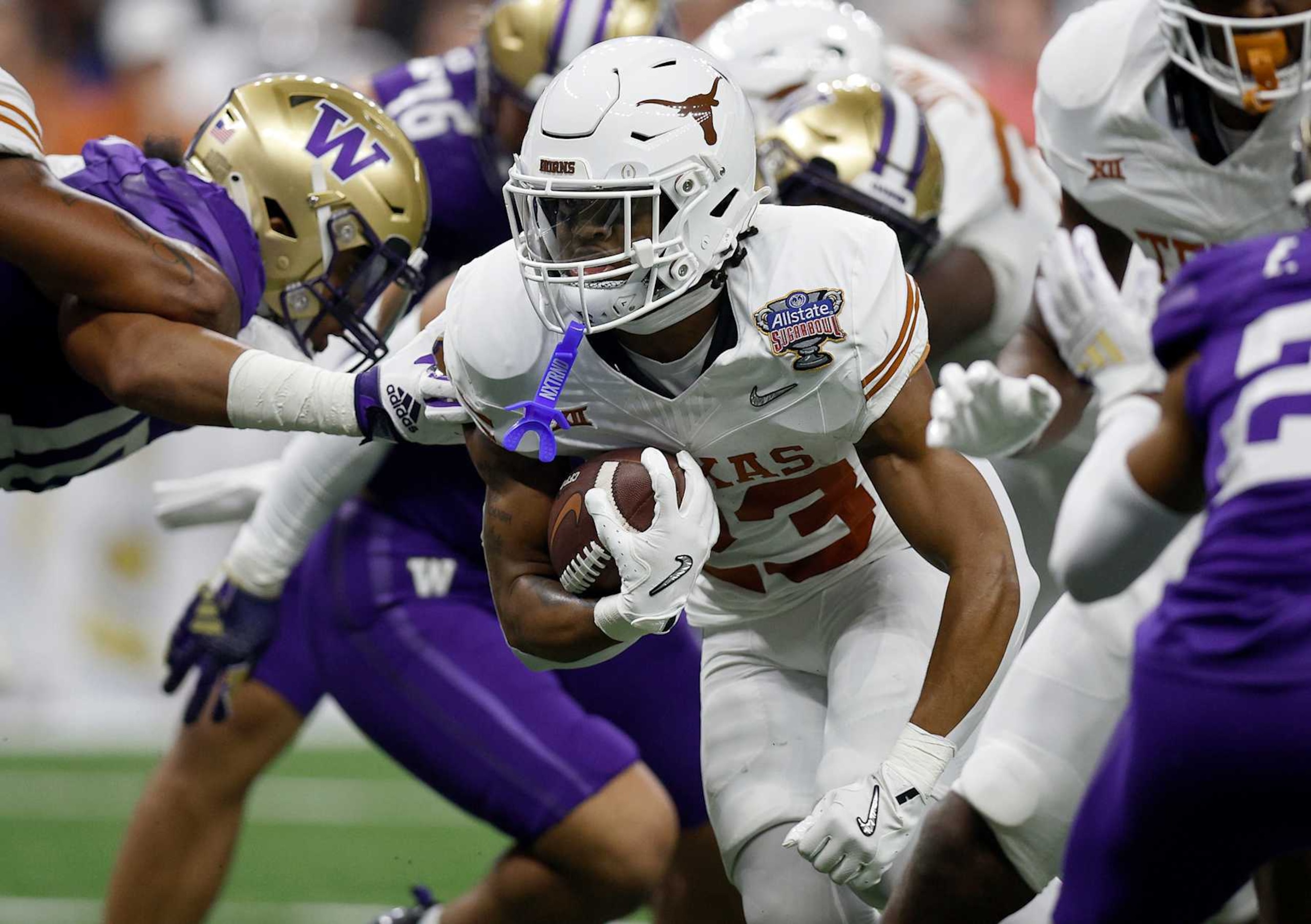 NEW ORLEANS, LOUISIANA - JANUARY 01:  Jaydon Blue #23 of the Texas Longhorns carries the ball during the first quarter against the Washington Huskies during the CFP Semifinal Allstate Sugar Bowl at Caesars Superdome on January 01, 2024 in New Orleans, Louisiana. (Photo by Sean Gardner/Getty Images)