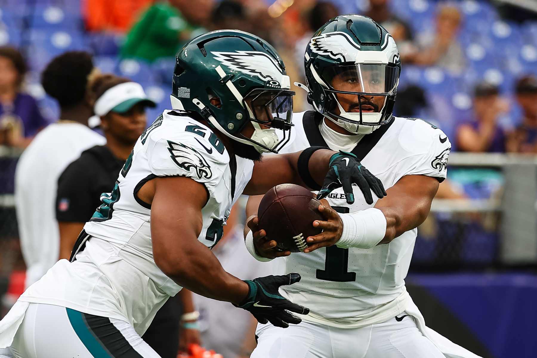 BALTIMORE, MD - AUGUST 09: Jalen Hurts #1 of the Philadelphia Eagles hands the ball off to Saquon Barkley #26 before a preseason game against the Baltimore Ravens at M&T Bank Stadium on August 9, 2024 in Baltimore, Maryland. (Photo by Scott Taetsch/Getty Images)